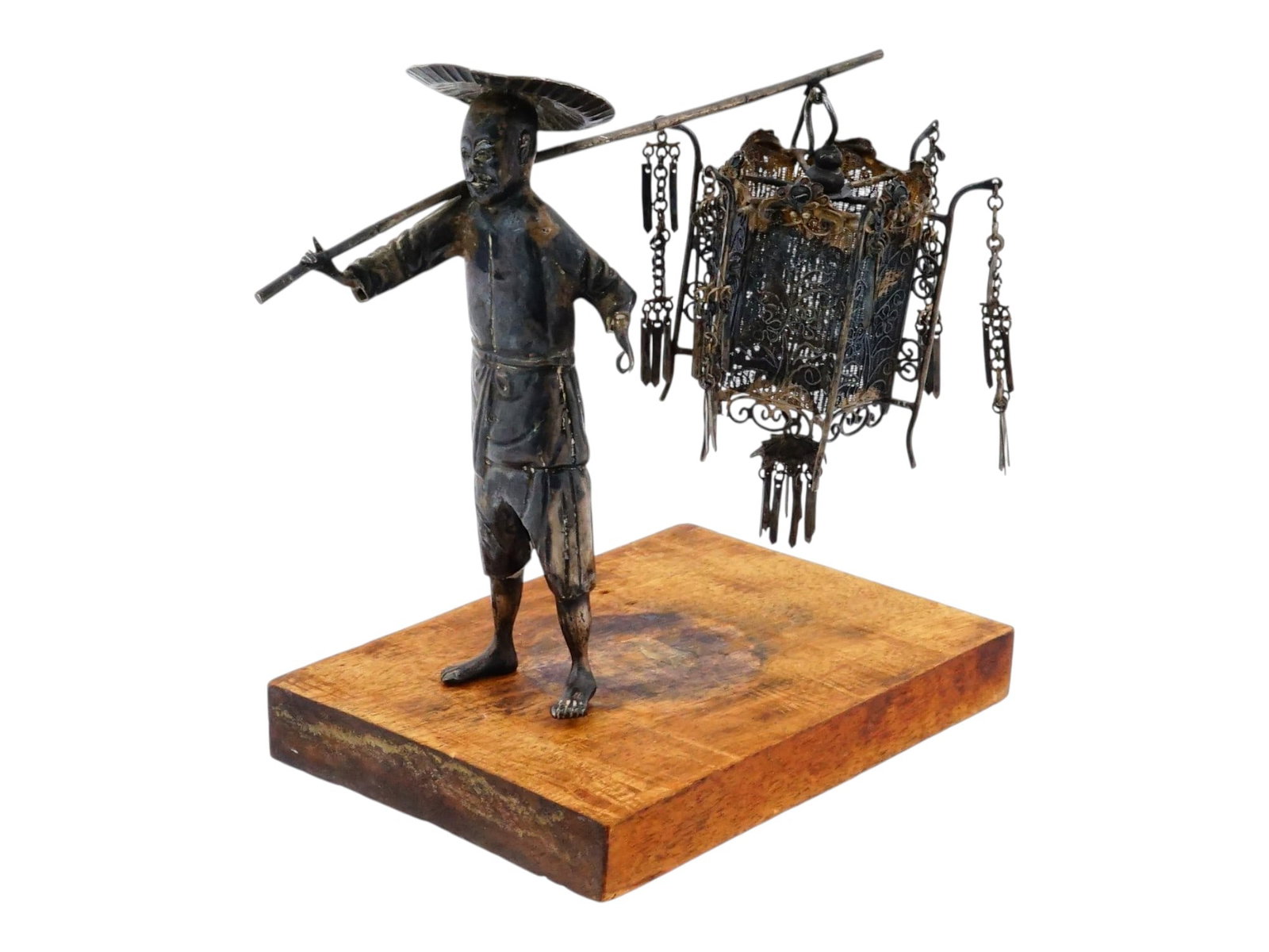 ANTIQUE CHINESE EXPORT SILVER SCRATCH BUILT FIGURINE: An antique Chinese Export silver scratch built model of a man carrying a filigree lamp. Late Qing to Republic of China era, early 20th century. The figurine is mounted on a wooden stand. Collectible O