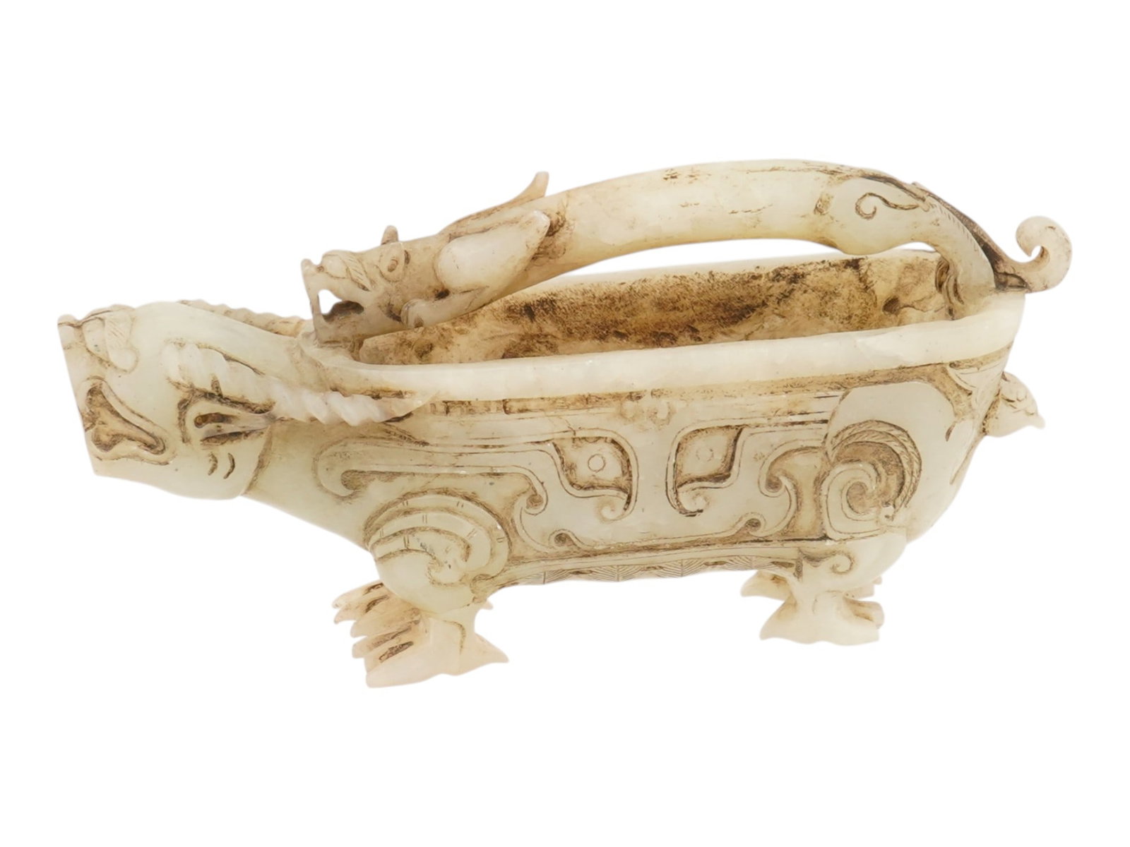 ANTIQUE CHINESE CARVED JADE DRAGON BEAST BOWL: An antique Chinese carved jade vessel described as a dragon-beast bowl or censer and sculpted in an archaic-inspired form that reflects traditional Chinese decorative arts. The piece features a promin