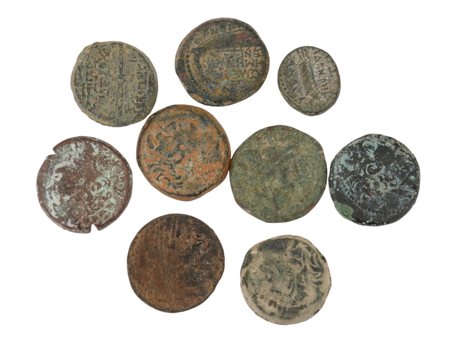 GROUP OF ANCIENT GREEK BRONZE COINS CA 400 TO 100 BC: A group of ancient Greek bronze coins, featuring a diverse array of designs, circa 400 to 100 BC. This remarkable assortment showcases the rich numismatic heritage and intricate artistry of this histo