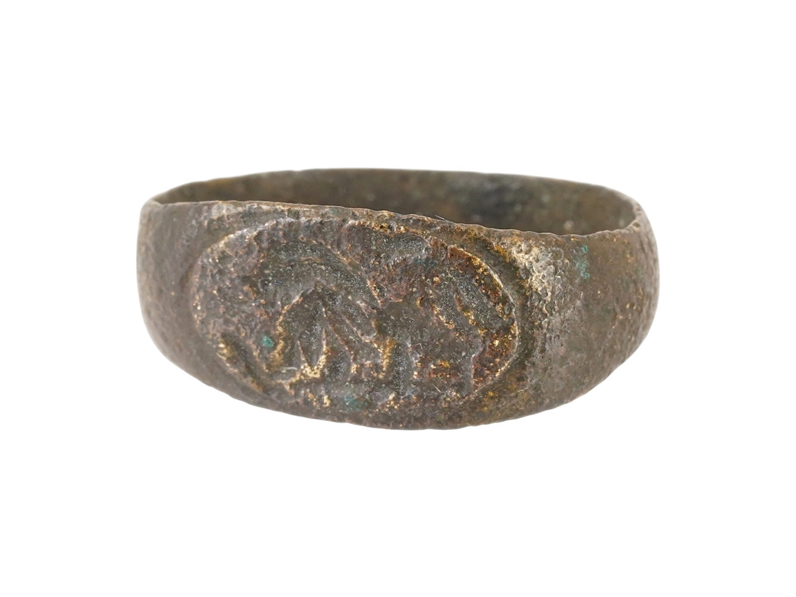 ANCIENT ROMAN BRONZE SIGNET RING 100 TO 300 AD: An ancient Roman bronze signet ring, dating from 100 to 300 AD. The ring features an oval bezel engraved with a design representing a lion in a field. Ancient Bronze Jewelry Wares, Archaeological Arti