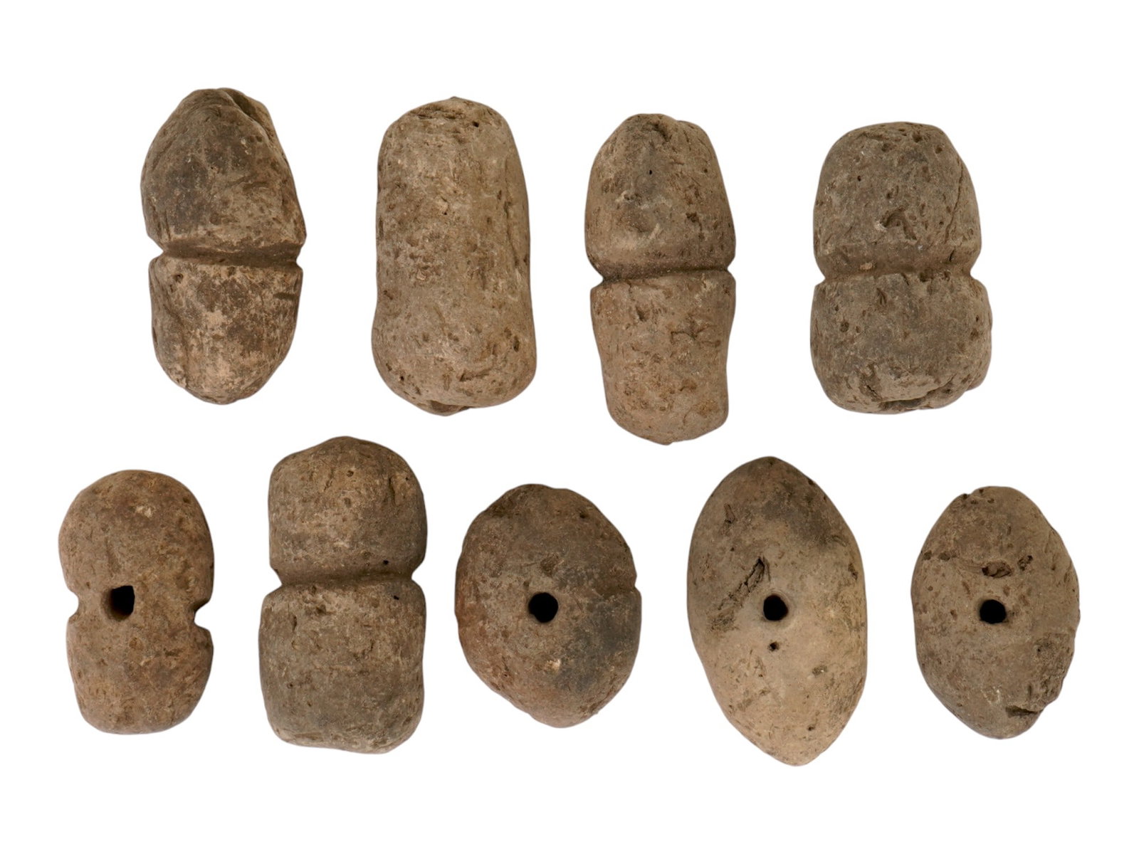 COLLECTION OF PREHISTORIC CLAY BEADS JEWELRY ARTIFACTS: A collection of prehistoric clay beads dating from approximately 7000 BC and later, representing some of the earliest forms of personal adornment and symbolic art. Hand-shaped and fired in primitive k