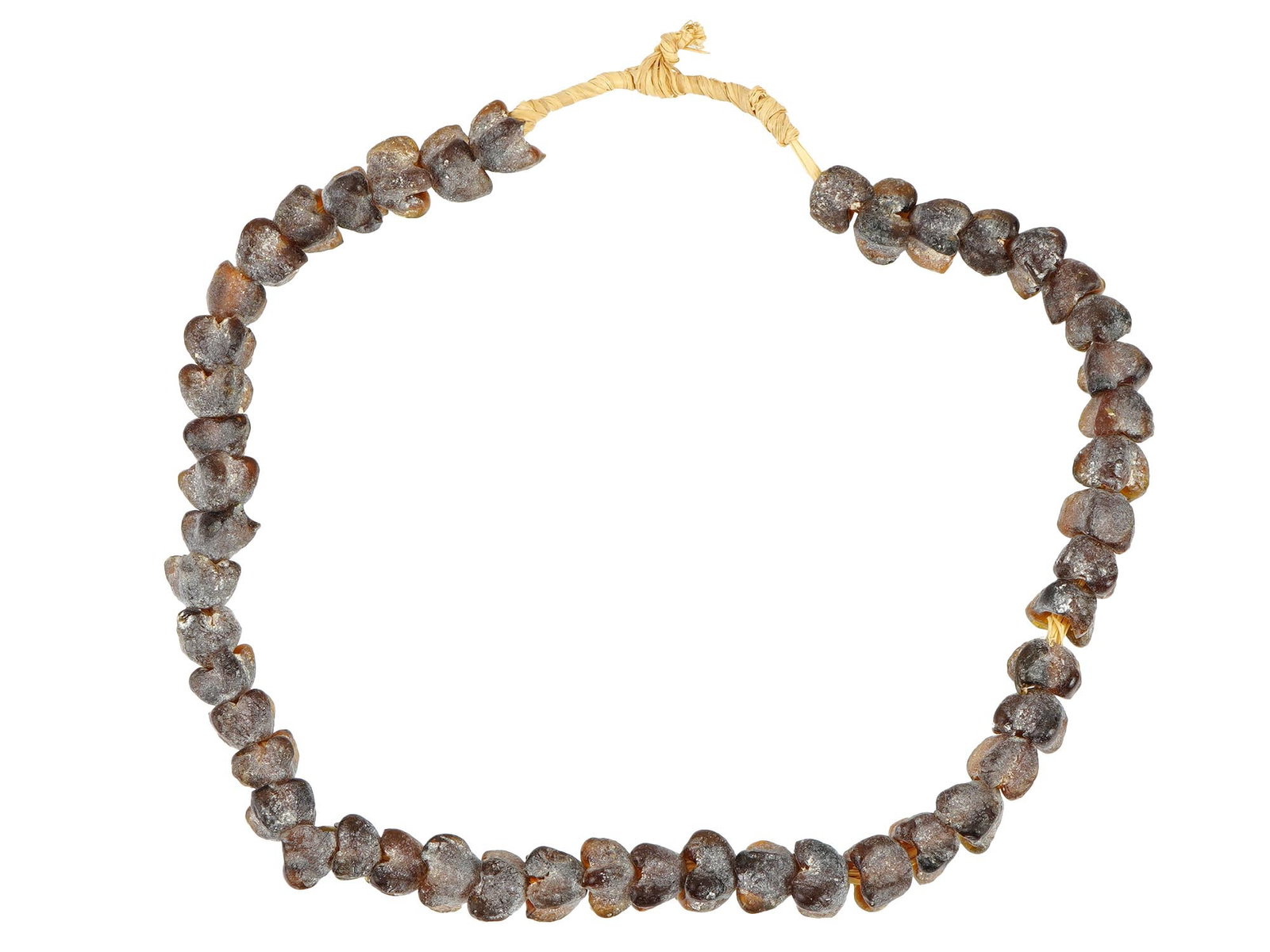 ANCIENT NECKLACE WITH GLASS BEADS OF FLORAL DESIGNS: An ancient necklace featuring glass beads with a honey-colored hue and floral designs. The beads exhibit intricate detailing. The honey color adds warmth and elegance to the necklace. Ancient Glass Be
