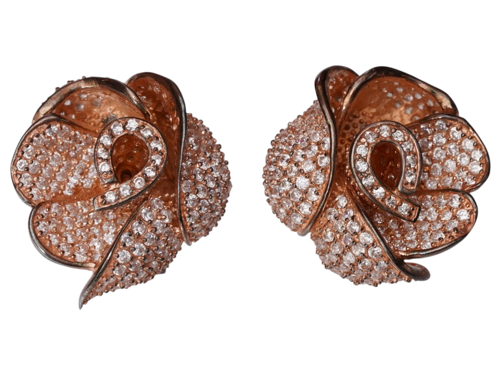 PAIR OF VINTAGE GILT STERLING SILVER EARRINGS W STONES: A pair of vintage earrings is executed in gilt sterling silver, featuring a sculptural rose motif with overlapping petals. Each flower head is embellished with a dense pave of round-cut champagne-hued