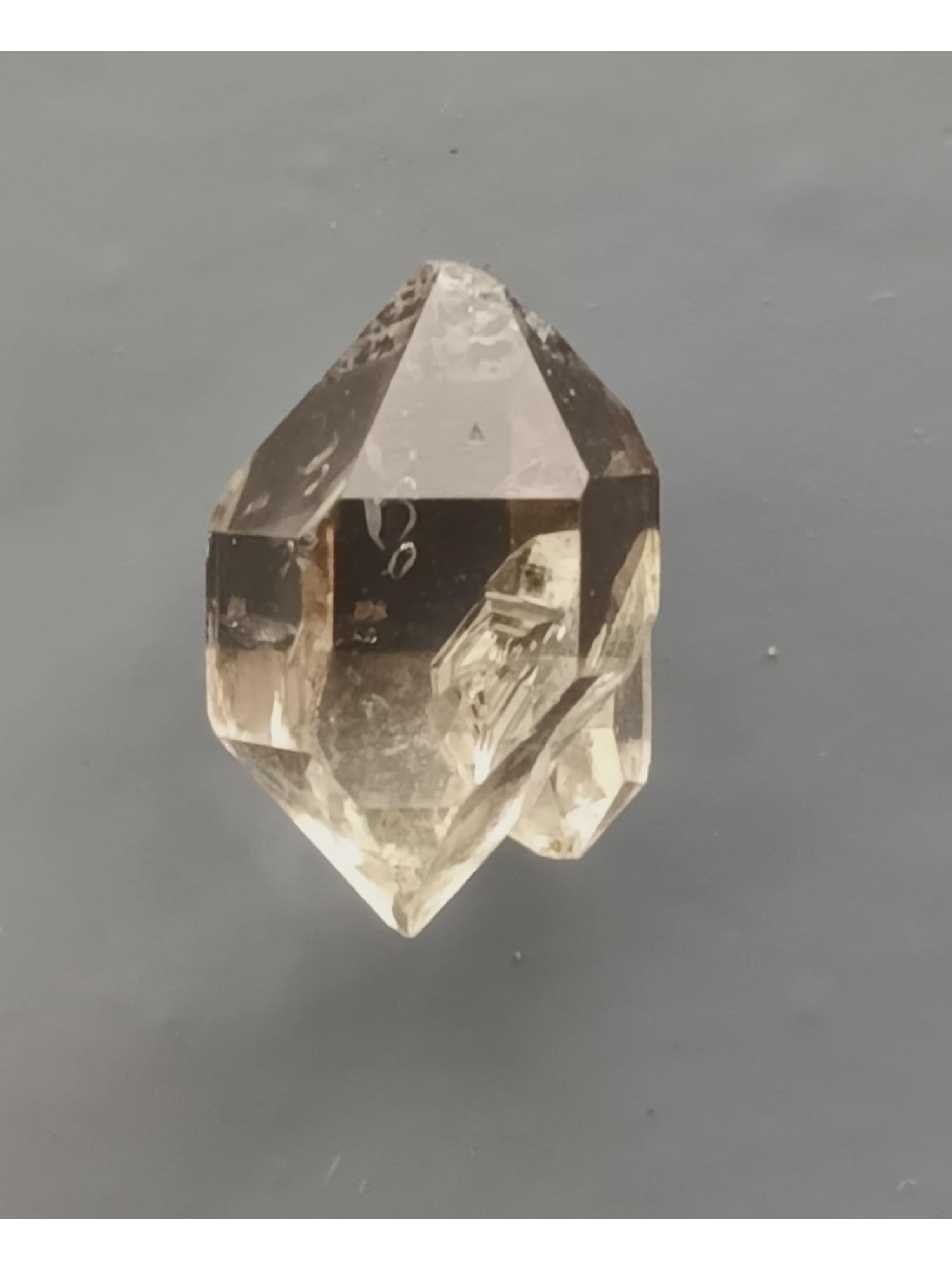 BITERMINATED QUARTZ CRYSTAL: Clear biterminated quartz crystal with 'sidecar" and hoppered contact. Weight: 1.71 grams. Origin: Lechang mine, Guangdong, China. (QU130/55) THIS LOT QUALIFIES FOR A 30-DAY UNCONDITIONAL RETUR
