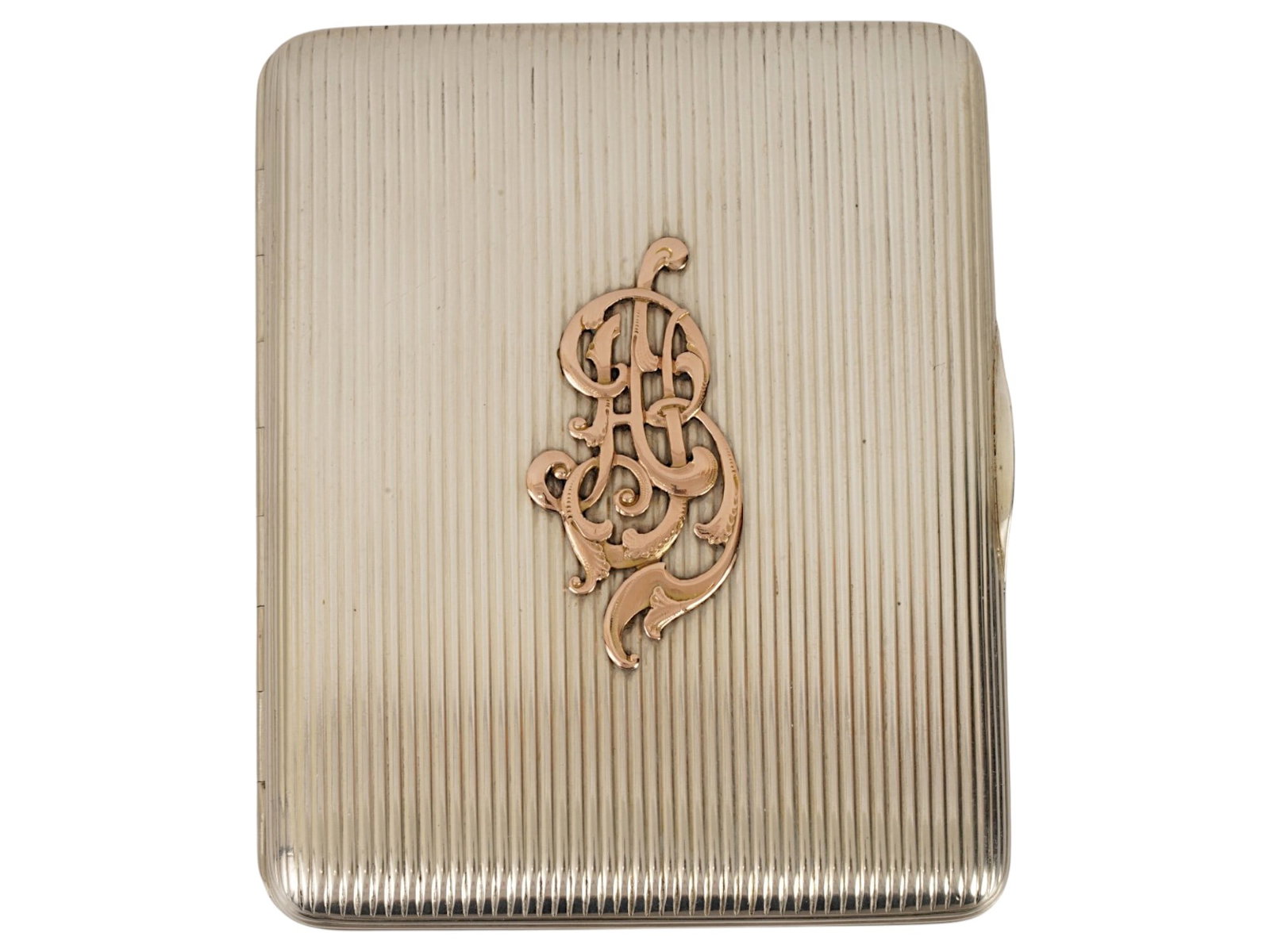 IMPERIAL RUSSIAN SILVER AND 14K GOLD CIGARETTE CASE: An Imperial Russian silver cigarette case with hinged lid. Dated ca. 1900s. Gold monogram overlay on the obverse. Gold-wash interior. Engraved dedication on the inside: Fur freundlichen Erinnerungen, 