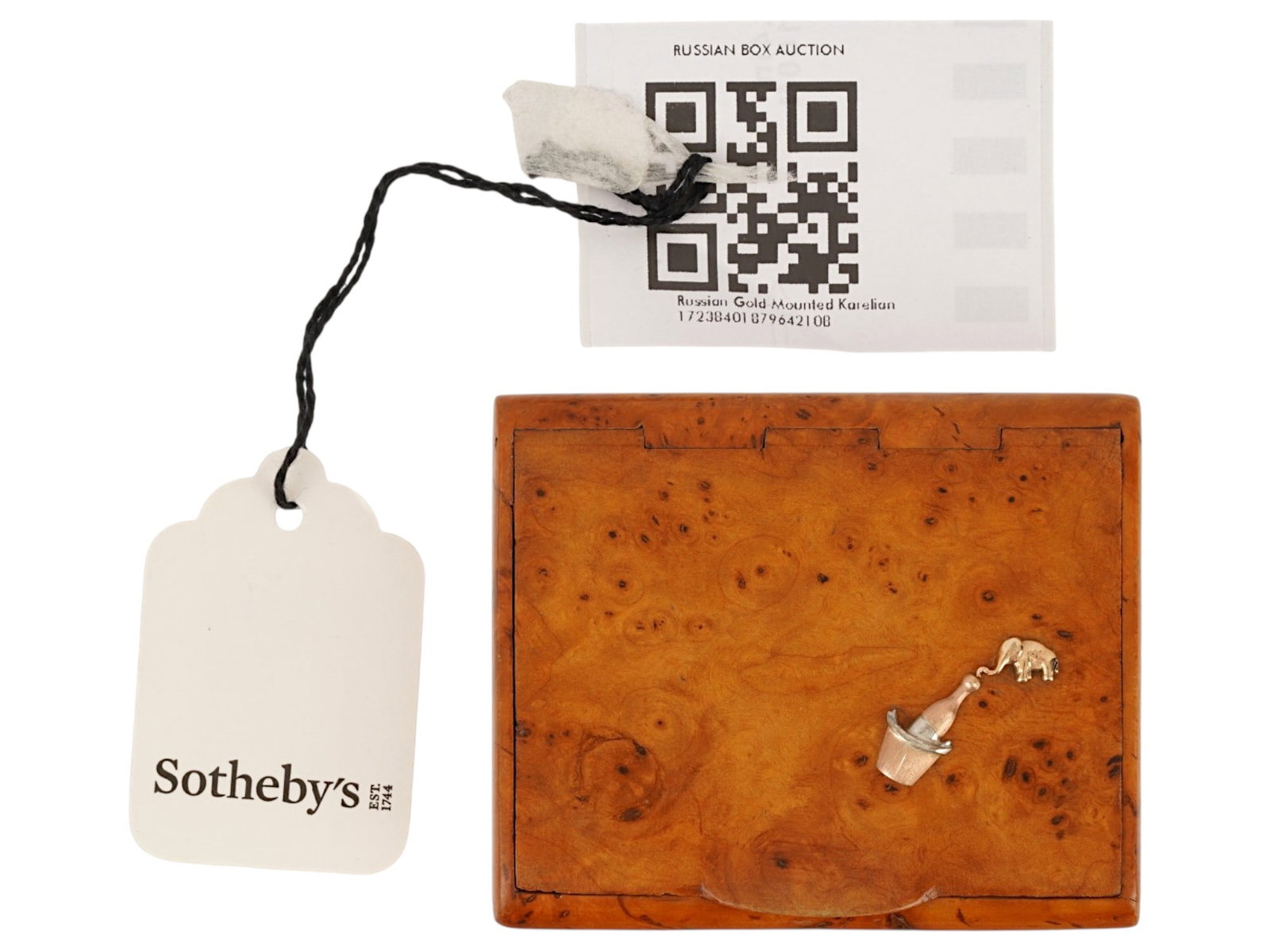 IMPERIAL RUSSIAN KARELIAN BIRCH WOOD CIGARETTE CASE: An Imperial Russian carved Karelian birch cigarette case with hinged lid. Dated ca. 1900. Gold overlay elephant and bottle of champagne on the obverse. Unmarked. Provenance: Sothebys Auctions, the lab