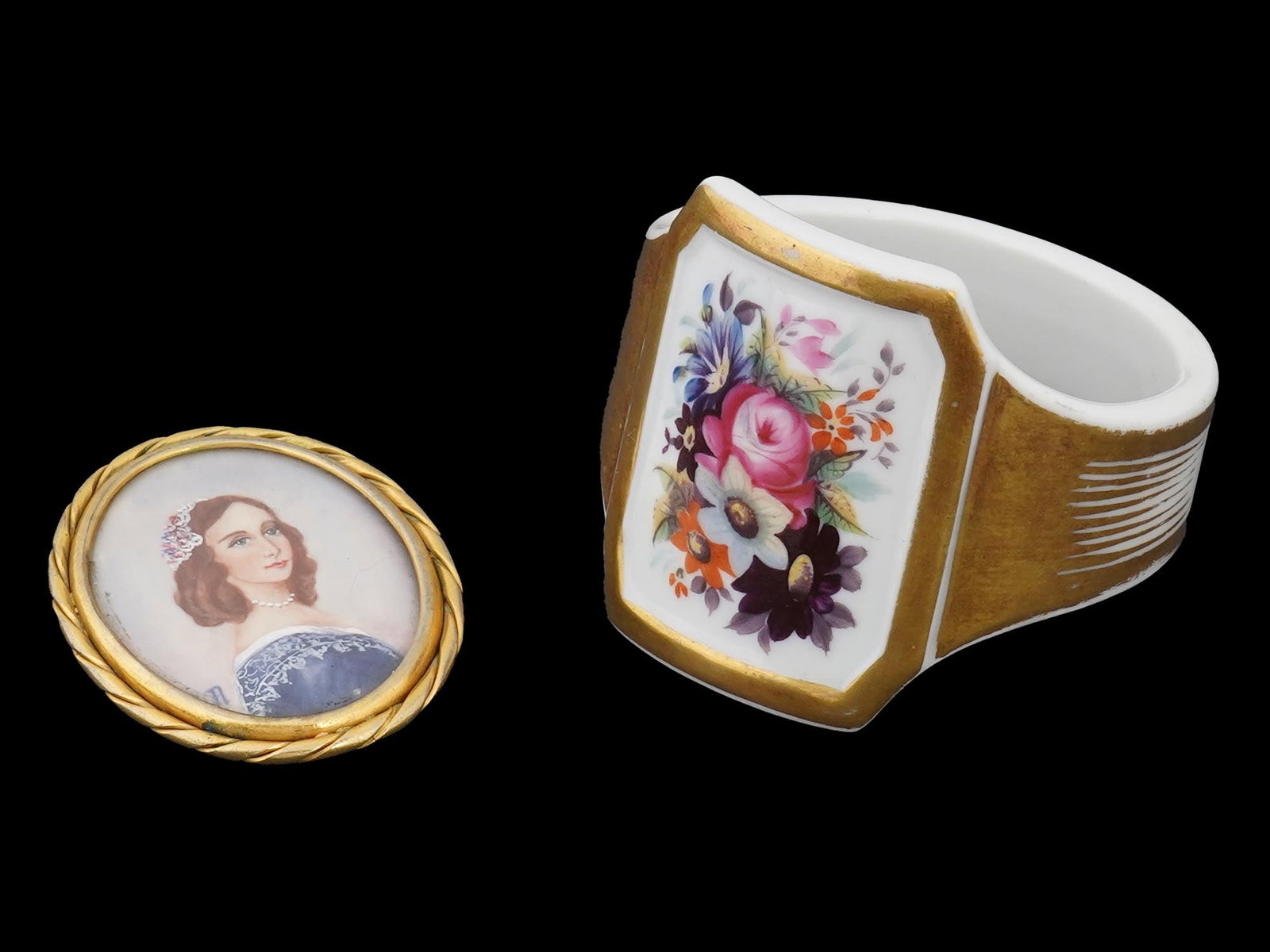 MINIATURE PORTRAIT ON PORCELAIN AND KMP NAPKIN RING: A lot of two porcelain items including a brooch with a miniature portrait of a woman in a gold colored frame, signed lower left. And a white porcelain napkin ring featuring a gold trim and a floral de