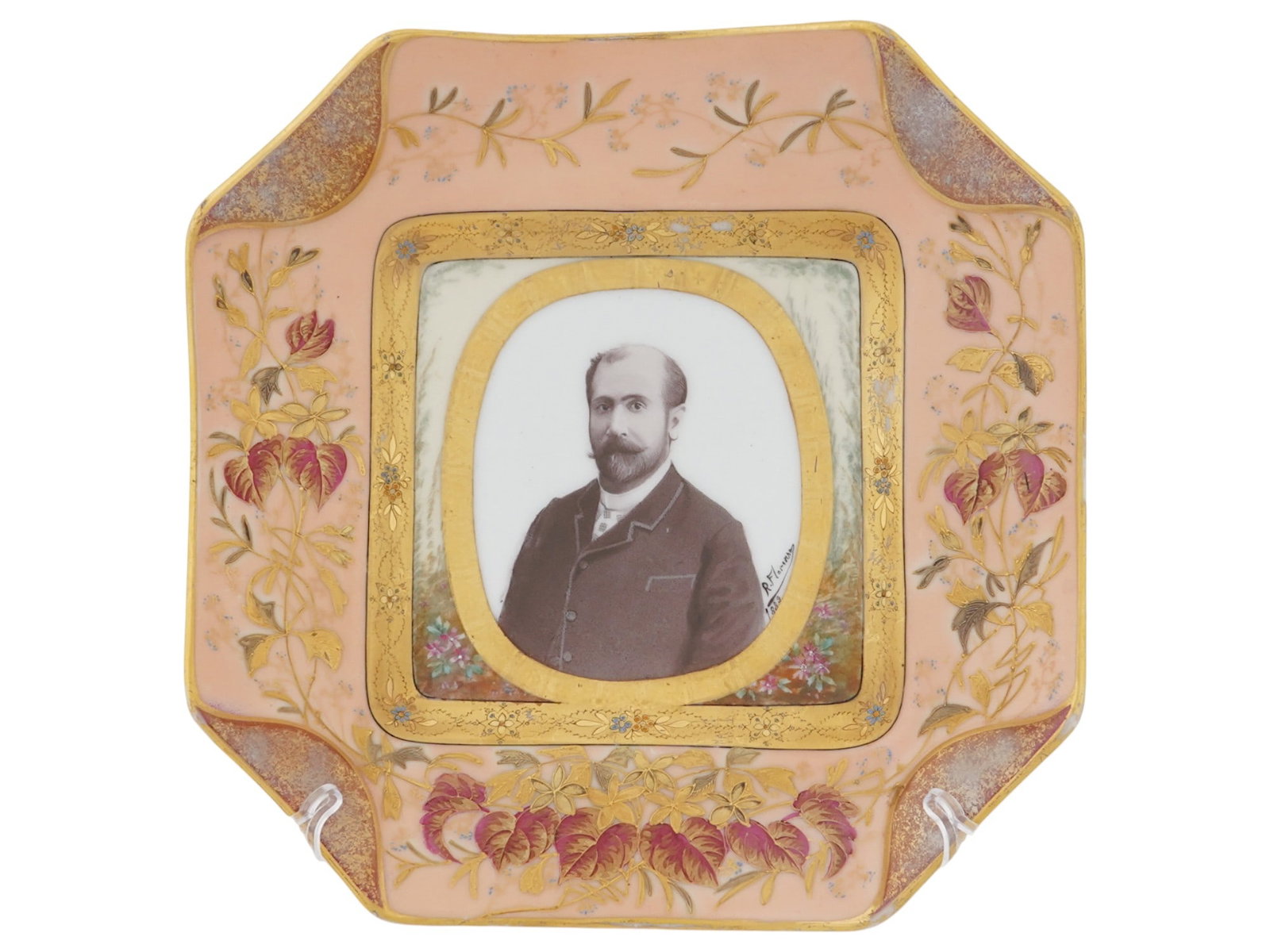 ANTIQUE SPANISH BARCELONA PORCELAIN CABINET PLATE: An antique Spanish Barcelona porcelain cabinet plate of unusual form. The plate is designed as a photo frame with a double gold-tone border and decorated with floral and foliate decoration in pastel a