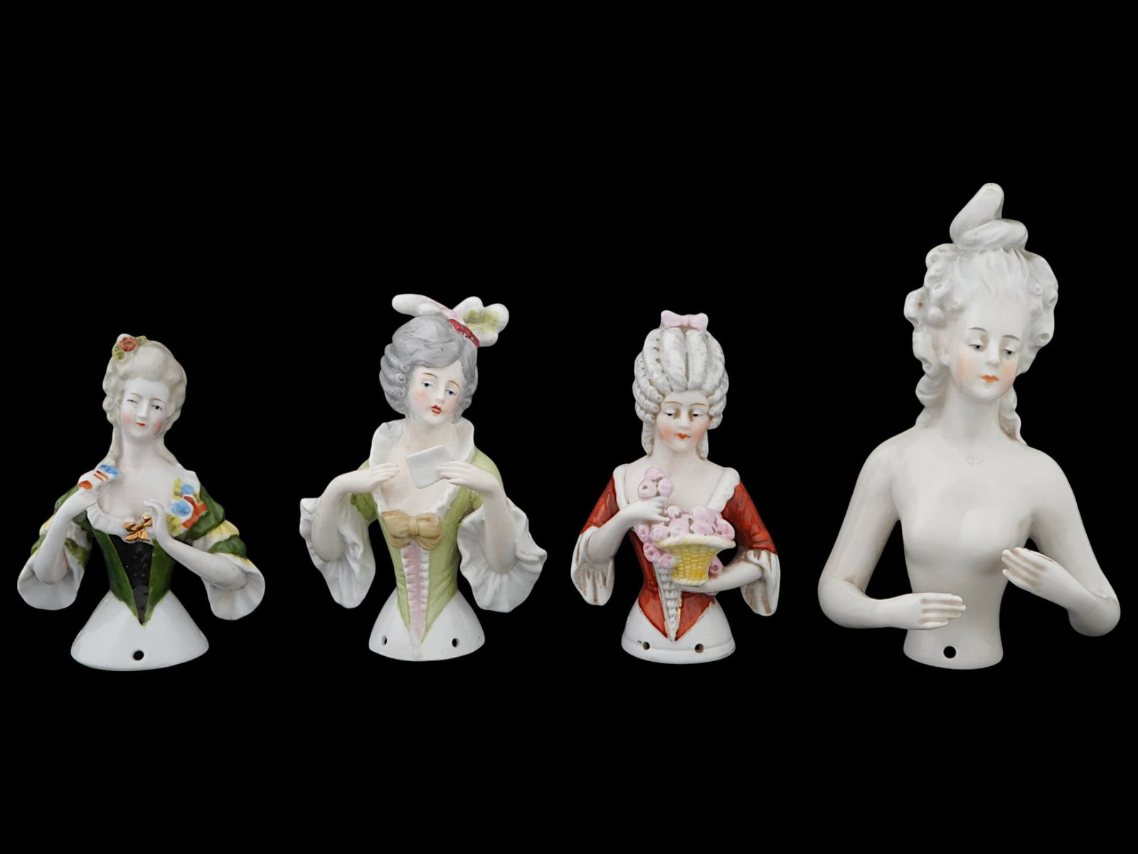 LOT OF GERMAN LADY HALF DOLL PORCELAIN PINCUSHIONS: A lot of four German half doll glazed porcelain figural pincushions. The wares depict half figures of ladies in the Rococo manner. Each is marked, Germany, and numbered, on the backside. Antique and V