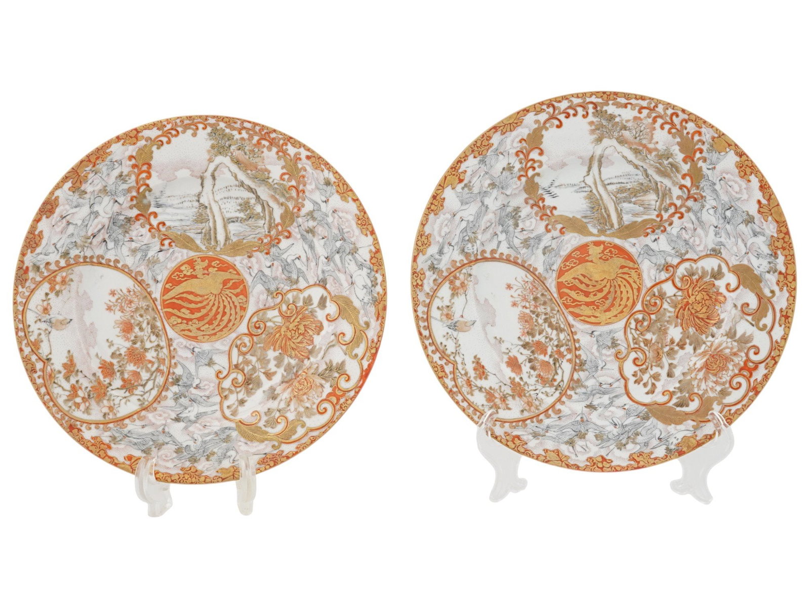 PAIR OF ANTIQUE JAPANESE KUTANI PORCELAIN CHARGERS: A pair of antique Japanese, late Edo period, Early Meiji era Kutani porcelain chargers. Each is adorned with fanciful floral, foliate and bird designs in iron red and gilt brocade delicately framing a