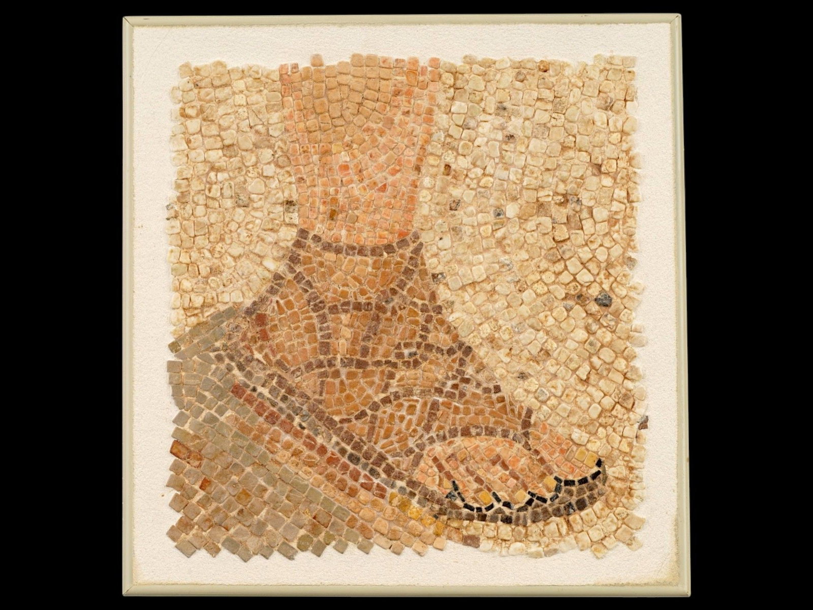 ANCIENT ROMAN MOSAIC FRAGMENT W OMAGE OF FOOT W SANDLE: An ancient Roman mosaic fragment, dating circa 100 to 300 AD and featuring the image of a foot wearing a detailed, strapped sandal. Executed with arranged stone tesserae, the composition reflects the 