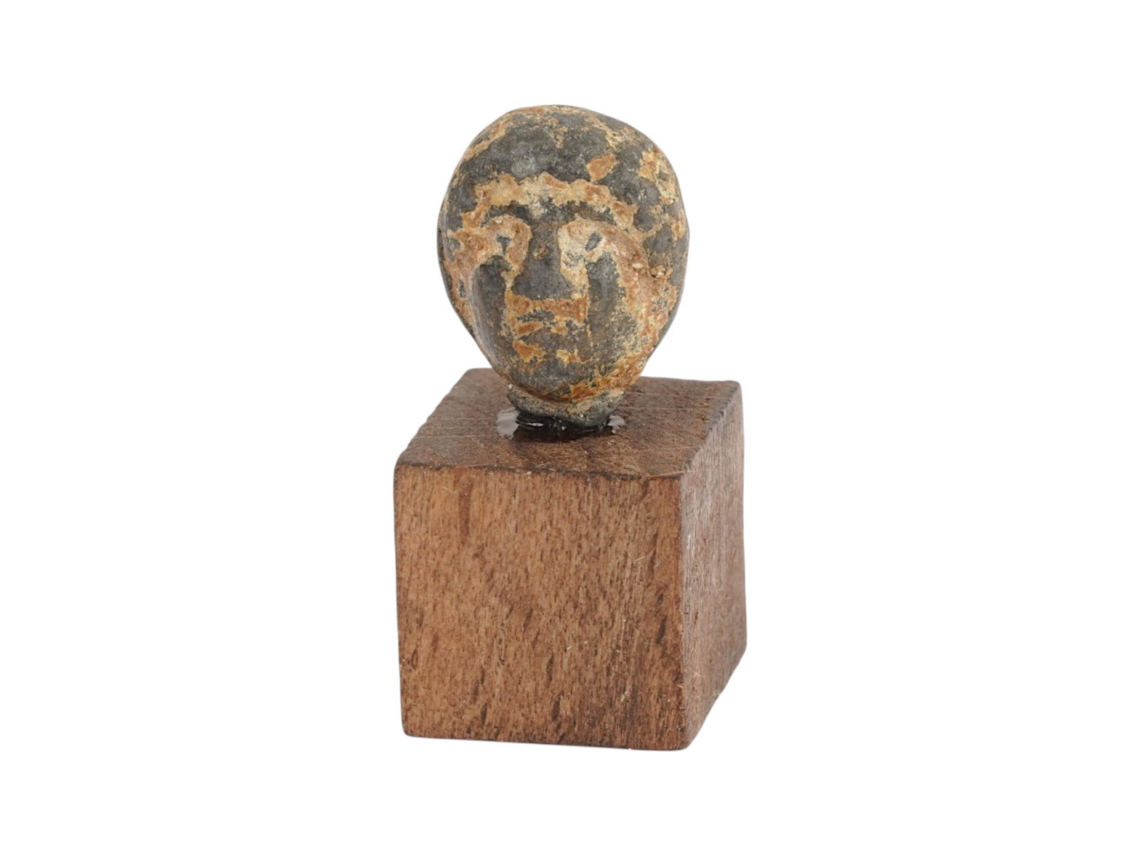ANCIENT ROMAN EMPIRE LEAD VOTIVE HEAD OF A GODDESS: An Ancient Roman lead female head sculpture, a votive offering to a goddess. Imperial Rome era, ca. 100 BC to 300 AD. The piece is mounted on a wooden stand. Historical Relics And Archaeological Finds