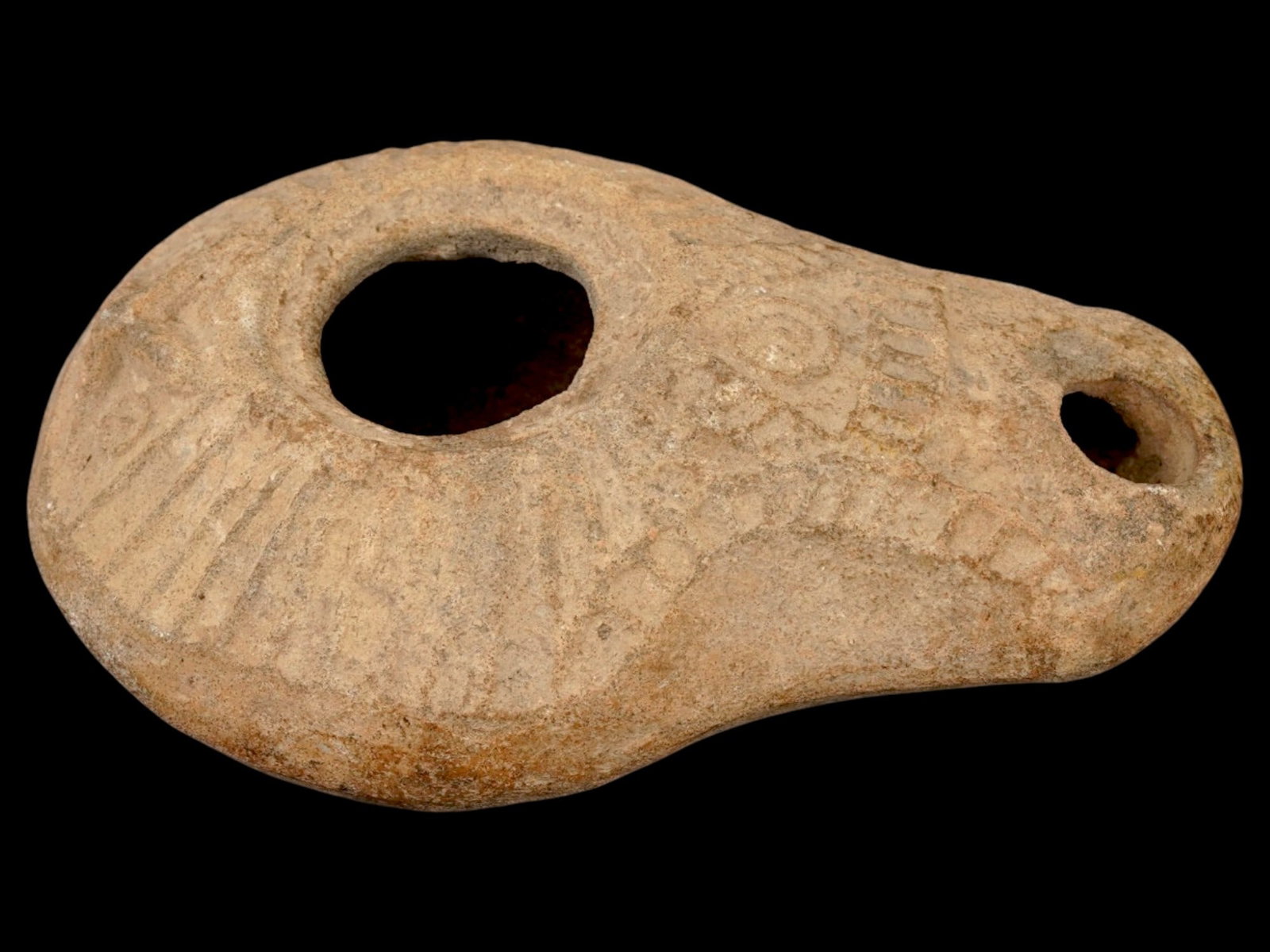 ANCIENT SAMARITAN JUDAICA TERRACOTTA OIL LAMP: An ancient Samaritan Judaica terracotta oil lamp dating from approximately 300 to 600 AD, featuring decorative motifs characteristic of Samaritan craftsmanship during the late Roman and Byzantine peri