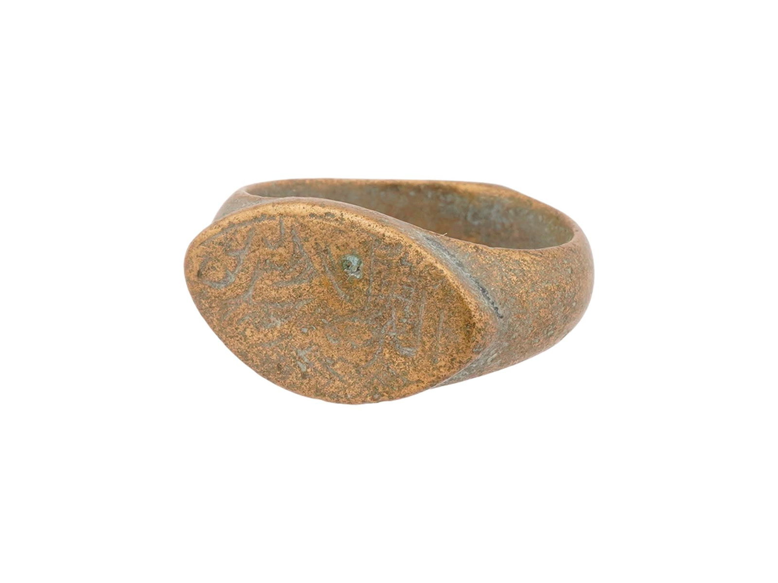 ANCIENT ROMAN BRONZE SIGNET RING 100 TO 300 AD: An ancient Roman bronze signet ring, 100 to 300 AD, features a cast hoop that widens into a flat, oval bezel. The bezel is hand-engraved with a stylized eye, an apotropaic symbol traditionally employe