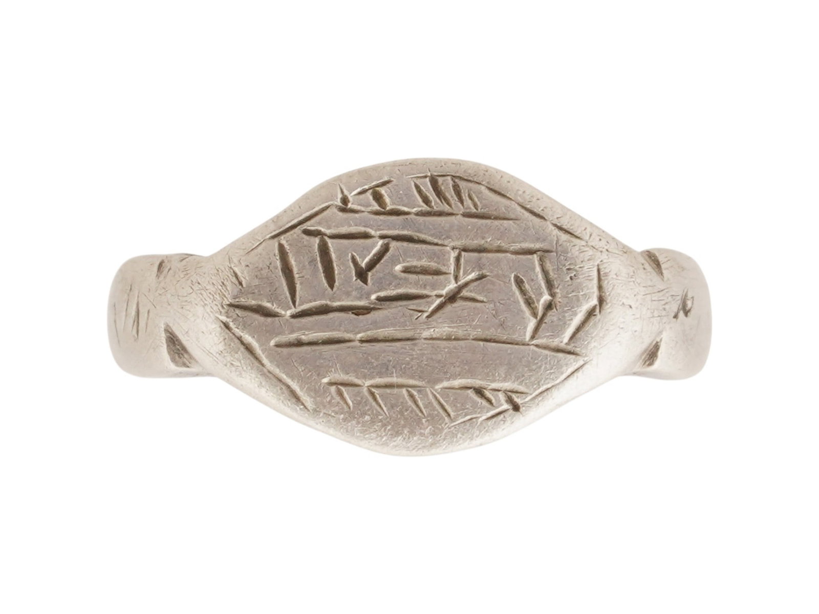 ANCIENT GRECO ROMAN SILVER SIGNET RING W LETTERS: An ancient Greco Roman silver signet ring, circa 1st millennium BC. It features a band that widens into a raised, oval-shaped bezel engraved with letters. Historical Collectibles And Archaeological Je