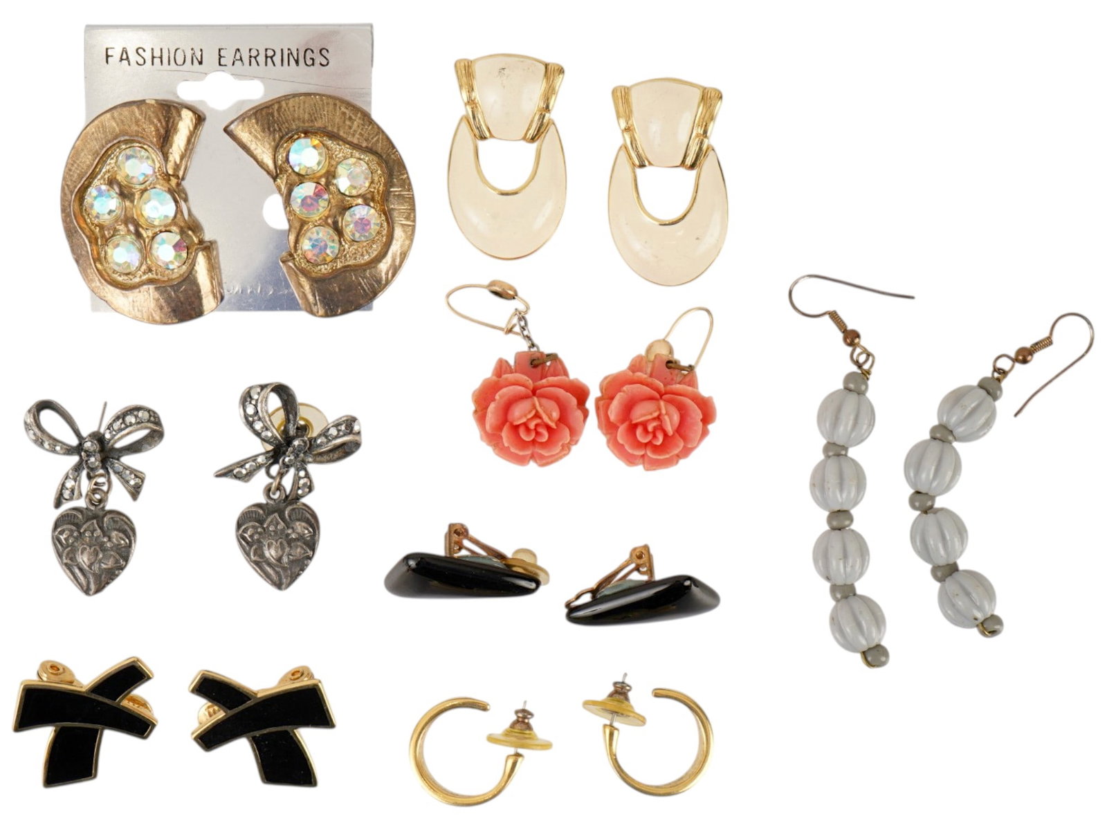 VINTAGE COSTUME JEWELRY HOOK STUD AND CLIP EARRINGS: A lot of vintage costume jewelry. The lot includes hook earrings, stud earrings, and clip earrings of various shapes and designs, some of which are covered with enamel. Circa mid to late 20th century.