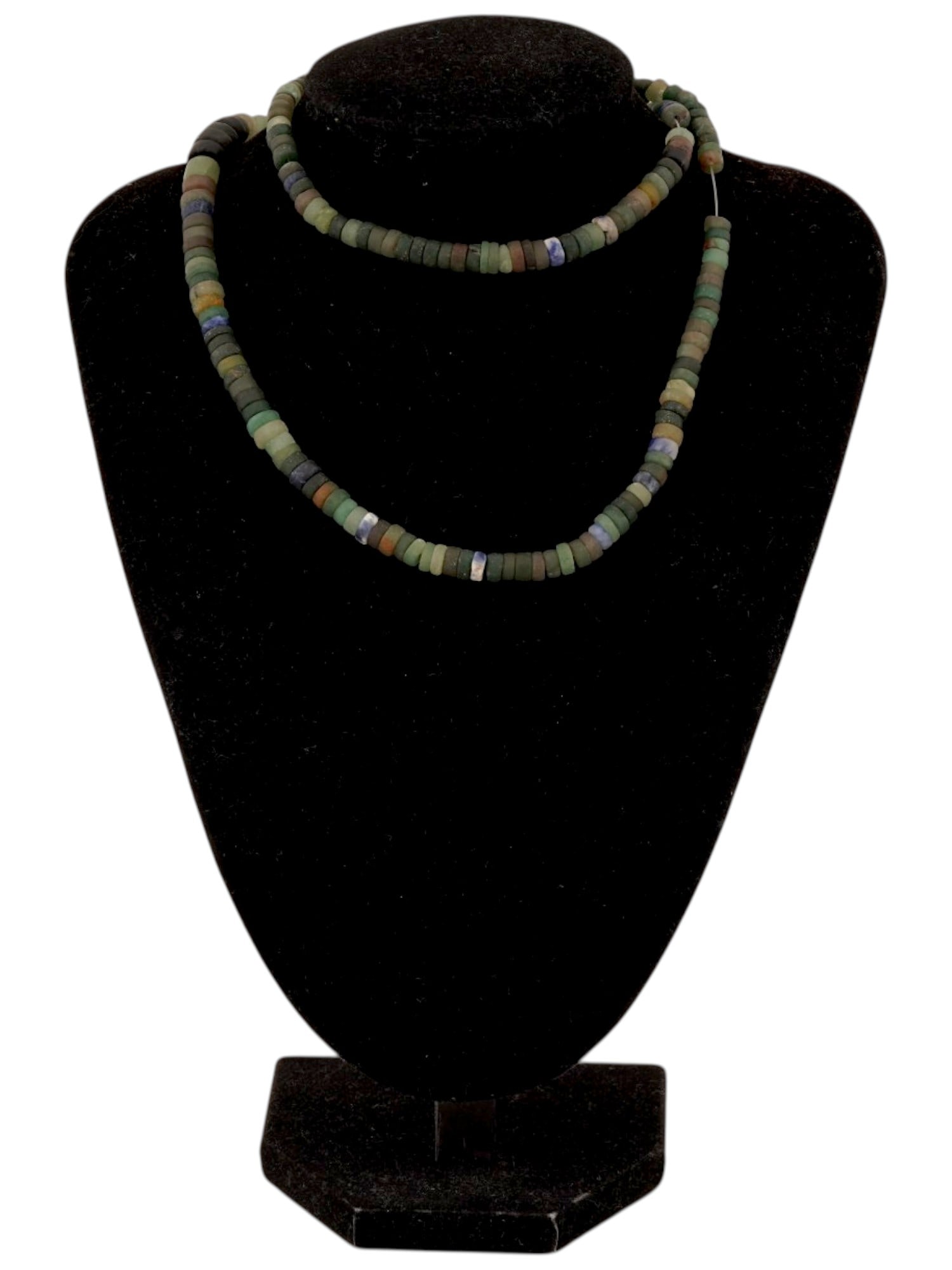ANCIENT PRE COLUMBIAN JADE BEAD NECKLACE: An ancient pre-Columbian jade bead necklace composed of shaped stone beads, reflecting the artistry and cultural significance of jade in the ancient civilizations of Central and South America. Revered