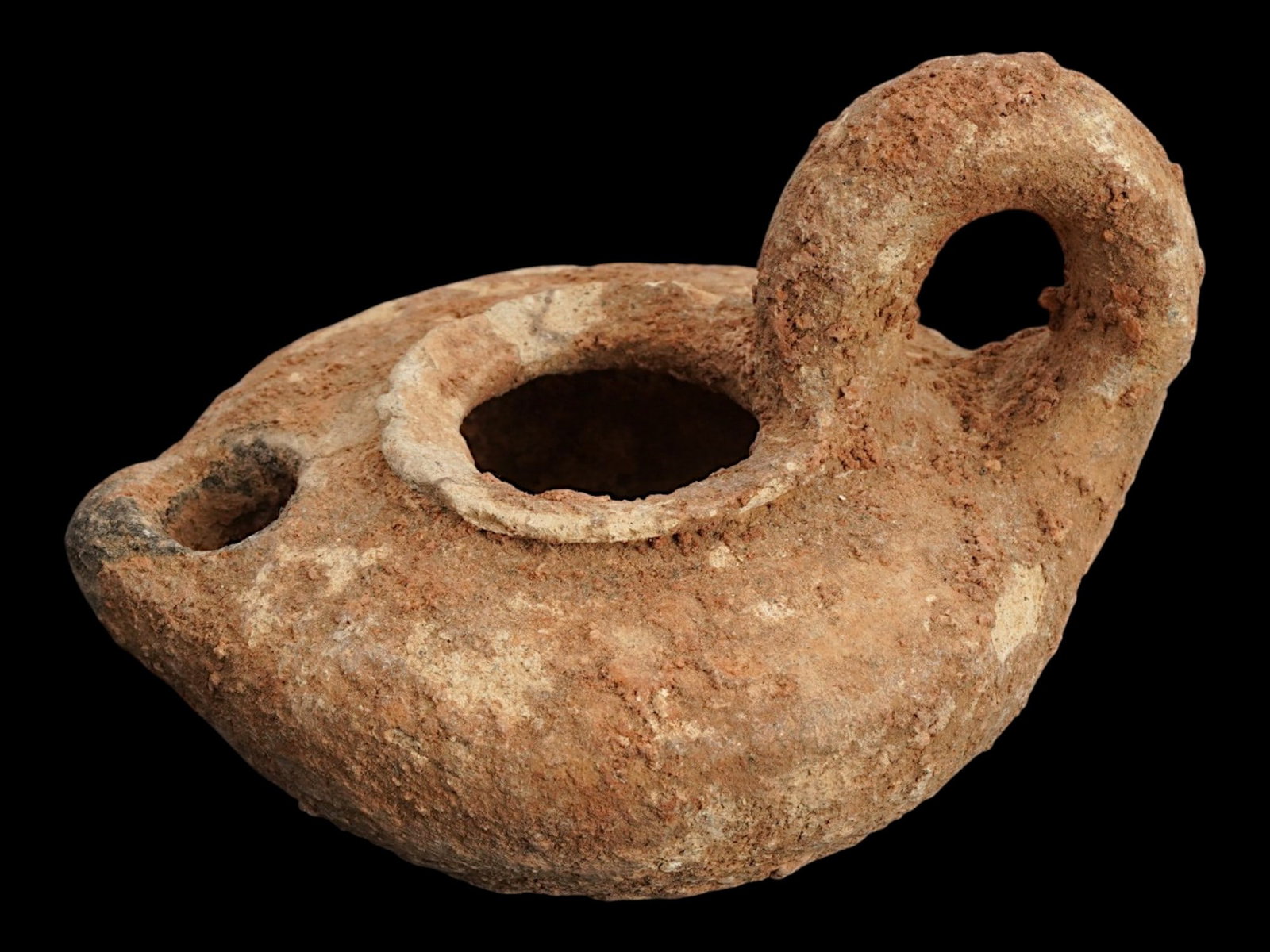 ANCIENT BYZANTINE EARLY ISLAMIC TERRACOTTA OIL LAMP: An ancient Byzantine Early Islamic terracotta oil lamp featuring an ovoid form, flared rim with a protruding nose and a handle. Circa: 500 to 700 AD. Made of unglazed clay. Historical Collectibles And