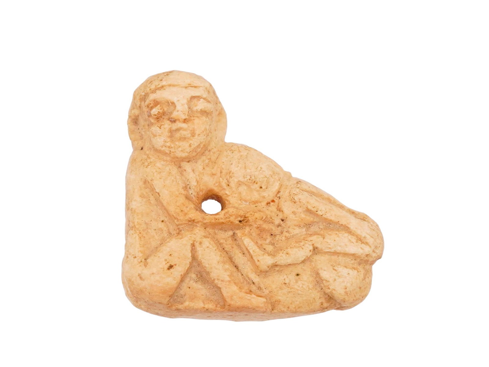 ANCIENT EGYPTIAN CARVED STONE PATAIKOS EROTIC PENDANT: An ancient Egyptian hand carved soft stone erotic pendant dating to the Late Period, circa 700 to 200 BC. Features Pataikos sitting on his phallus. He is an Egyptian genius or deity represented in the