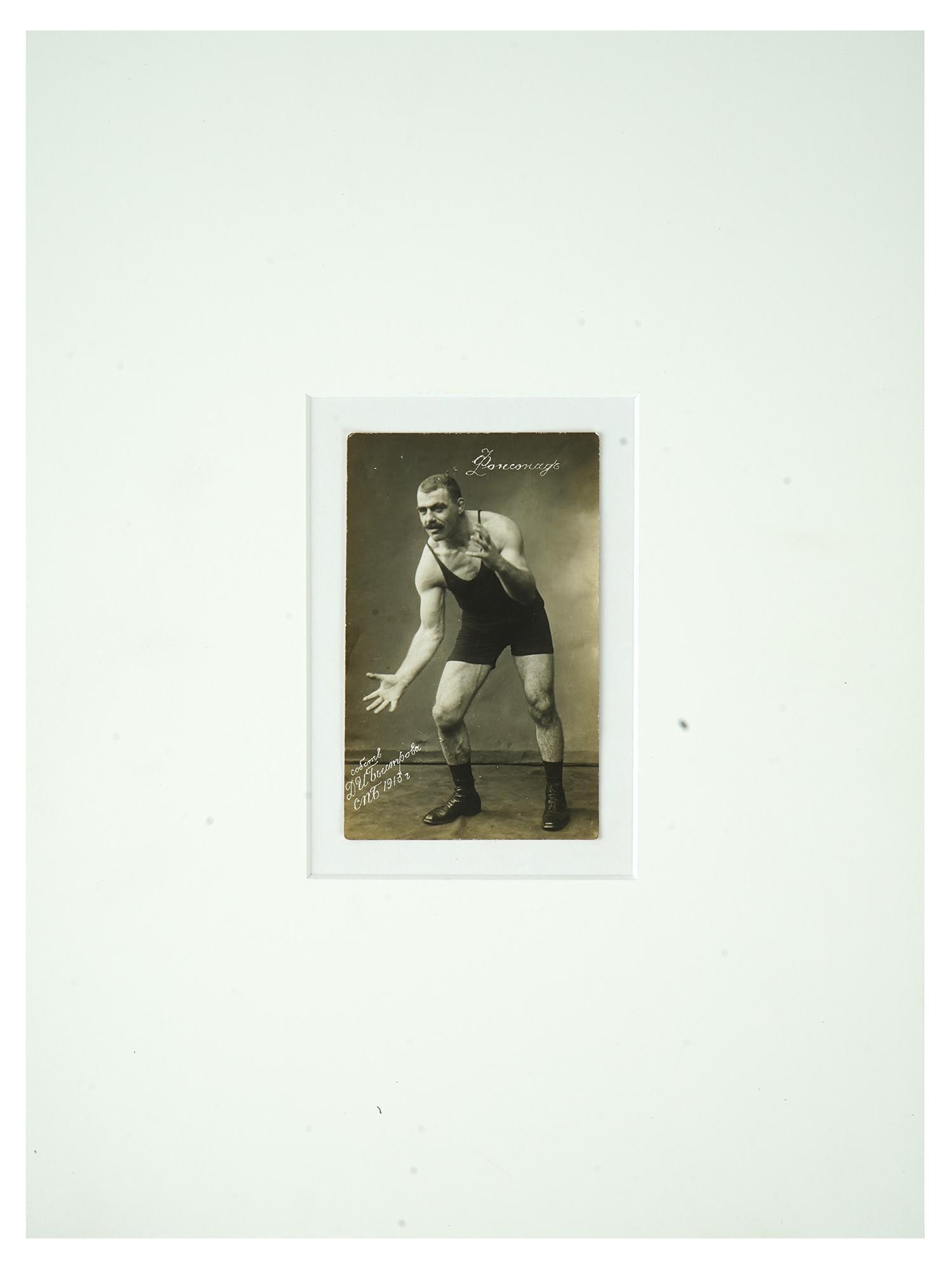 ANTIQUE RUSSIAN PHOTOGRAPH MALE WRESTLER BYSTROV 1913: An antique Russian black-and-white portrait photograph, depicting a male wrestler in the pose. The image is inscribed ?onsonade. Property of D. I. Bystrov, St. Petersburg, 1913. The photograph not onl