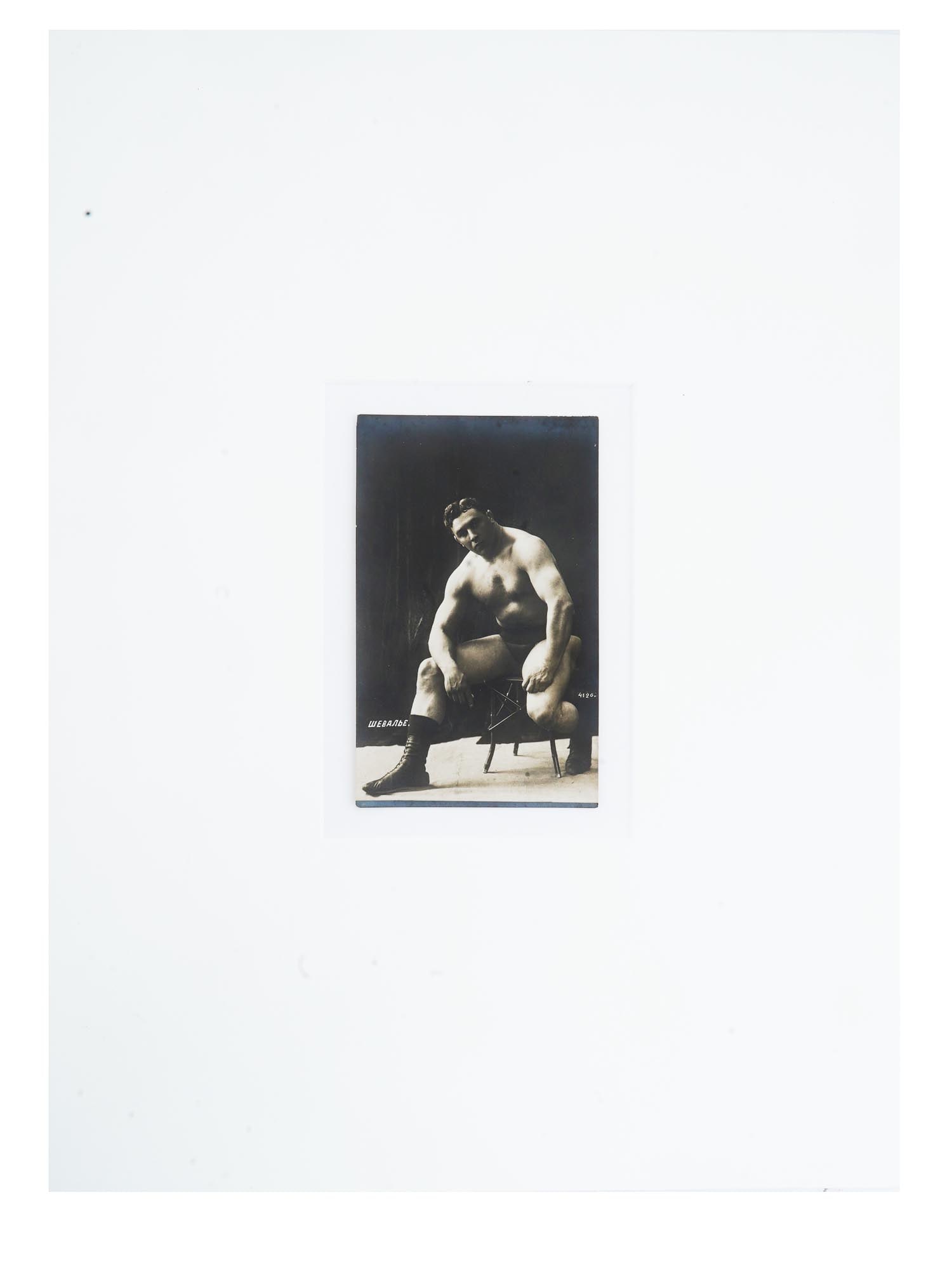 ANTIQUE RUSSIAN PORTRAIT PHOTO OF FRENCH WRESTLER: An antique Russian post card with a black and white photograph, depicting a studio portrait of Chevalier, a French wrestler. Circa: early 20th century. Titled, lower left. Numbered, 4126, lower right.