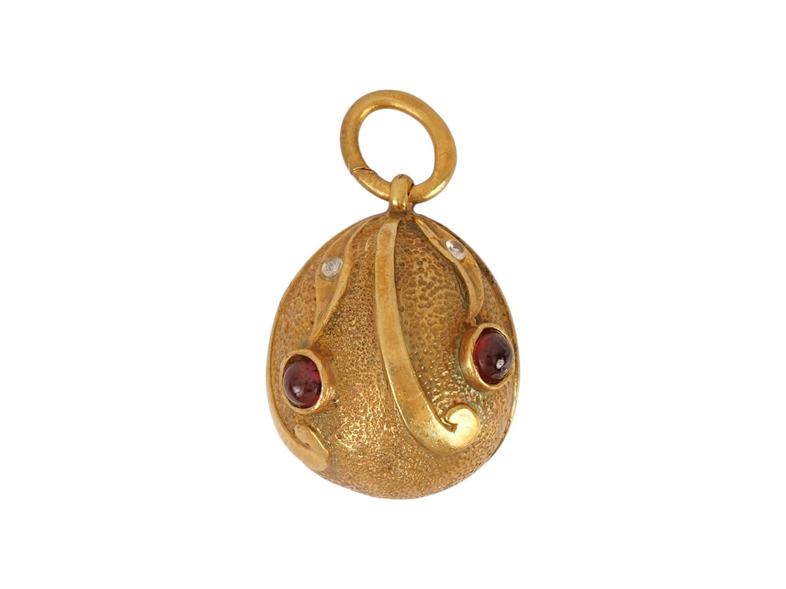 RUSSIAN GILT SILVER EASTER EGG PENDANT WITH GEMSTONES: A Russian gilt silver Easter Egg pendant. The exterior of the egg is made in a cellular design, adorned with a relief foliage ornament, and encrusted with gemstones. Hallmarked with manufacturer and 8