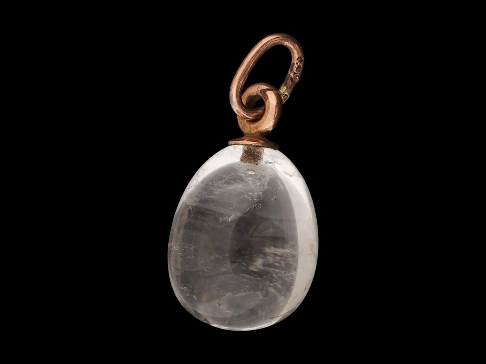 RUSSIAN 14K GOLD CARVED ROCK CRYSTAL EASTER EGG PENDANT: A Russian Easter egg pendant hand carved of natural rock crystal with 14k gold fittings to the body. Marked on the fitting ring with a 56 Russian gold standard for 14K gold, crossed anchors for St. Pe