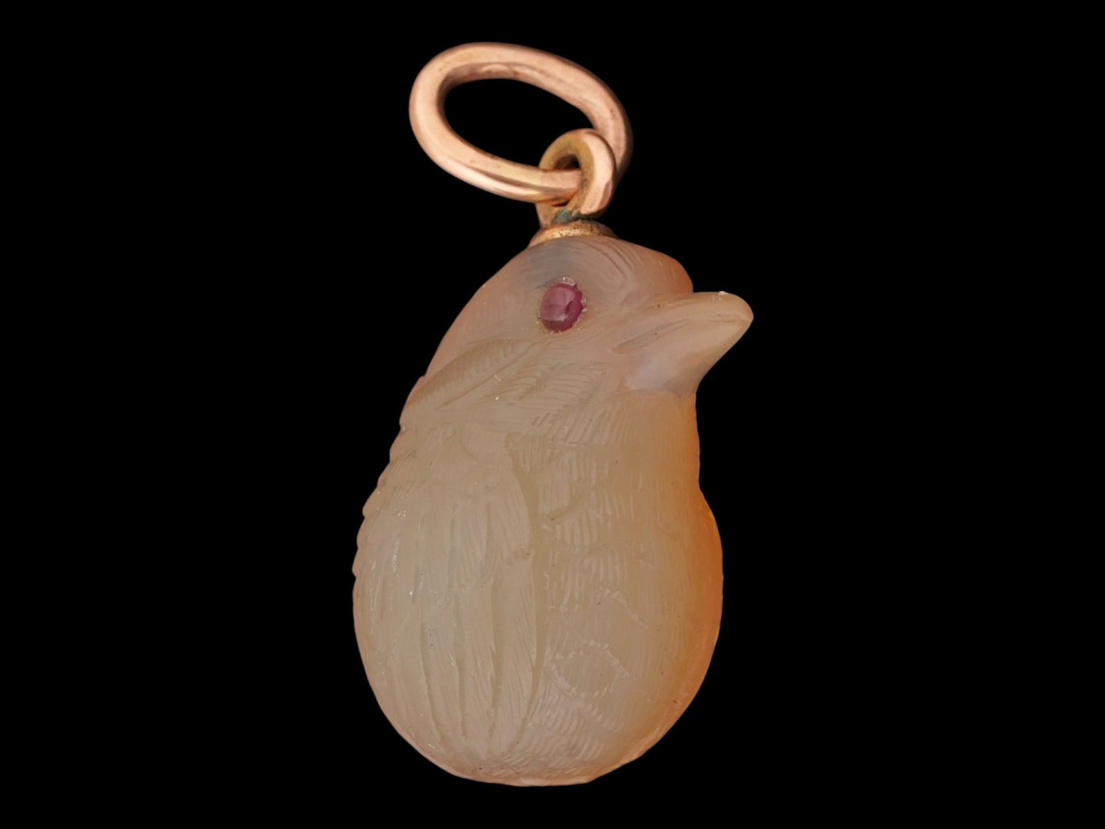 RUSSIAN AGATE RUBY AND 14K GOLD BIRD EGG PENDANT: A Russian gold mounted Easter egg pendant skillfully hand carved of natural agate as a humming bird set with ruby cabochon eyes. Marked on the fitting ring with a 56 Russian gold standard for 14K gold