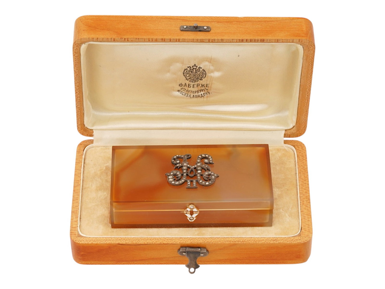 RUSSIAN AGATE ENAMEL AND DIAMONDS PRESENTATION BOX: A Russian carved agate stone imperial presentation box with diamonds. The lid features a gilt silver monogram of Nicholas II, embellished with diamonds. The furniture and a clasp are decorated with wh