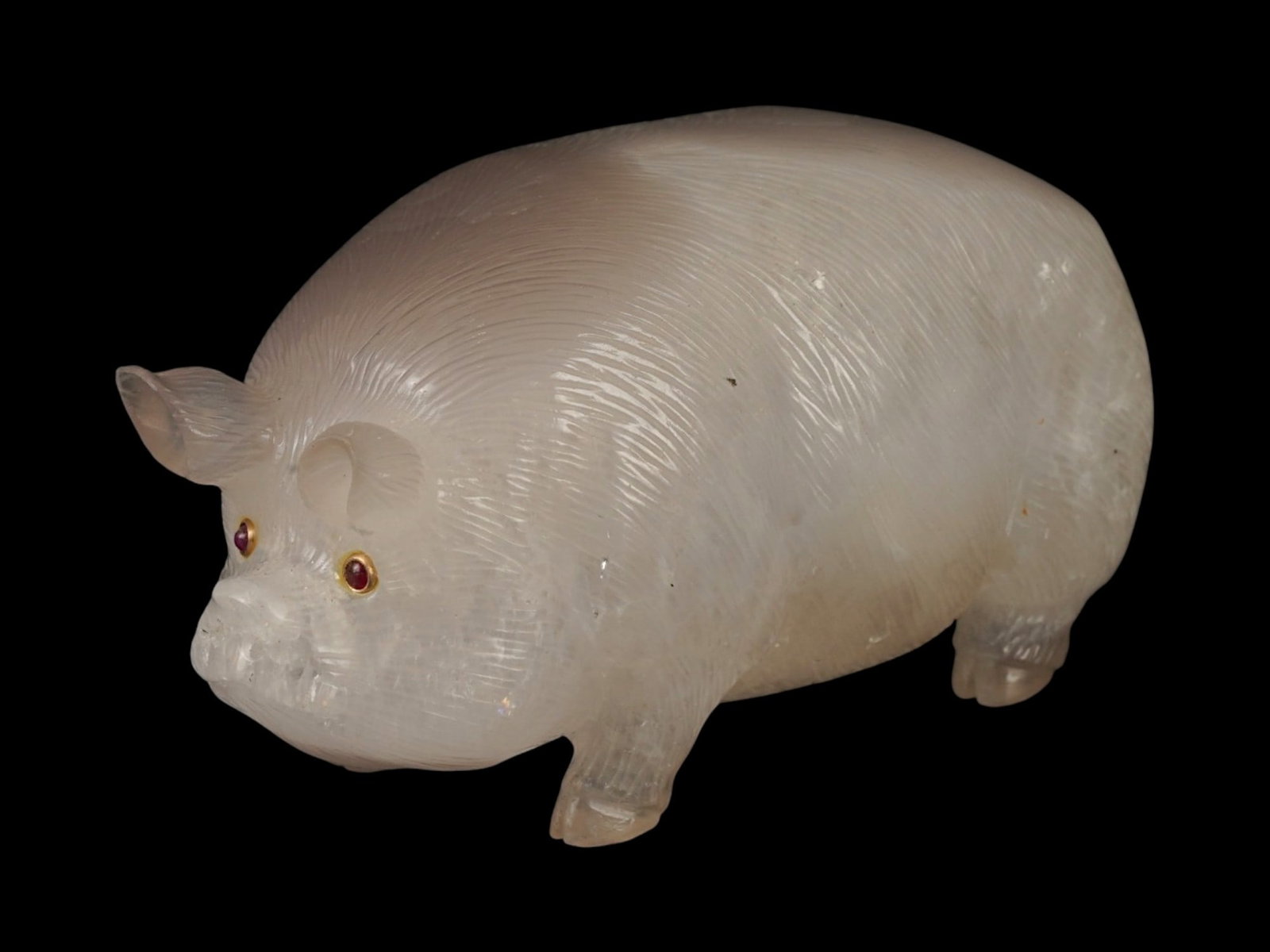 RUSSIAN CARVED QUARTZ PIG FIGURINE WITH GEMSTONE EYES: A Russian hand carved quartz figurine of a pig set with gemstone eyes in gold fittings. Hallmarked with the 56 Russian gold standard proof and the manufacturer marks. Russian Stone ?arved Figurines An