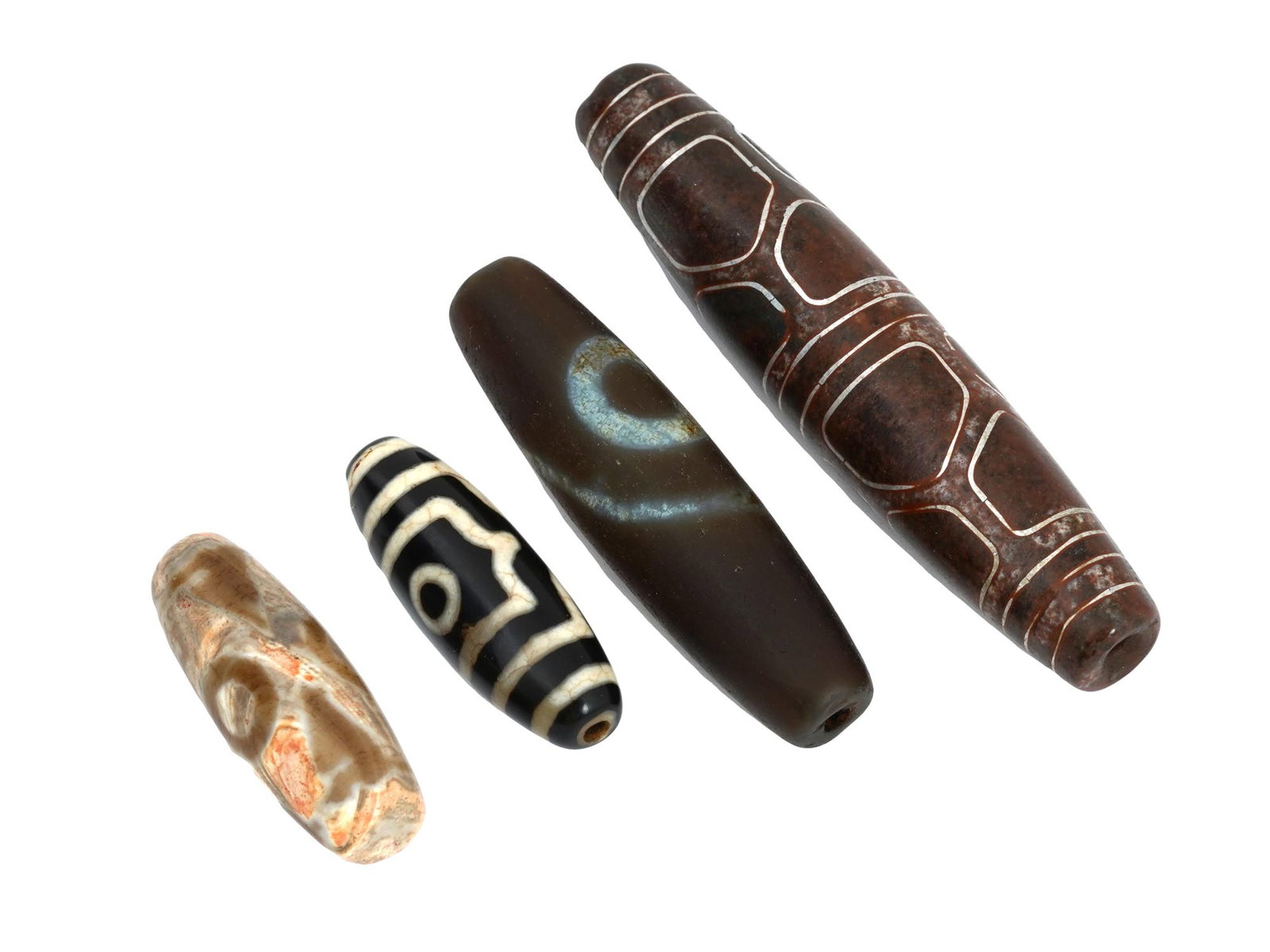 LOT OF TIBETAN DOUBLE LONGEVITY CARVED JADE DZI BEADS: A lot of four vintage archaistic manner hand carved Jade and Agate Dzi beads made in various sizes. The beads are adorned with dragon veins and eyes ornaments. A Dzi bead is a type of stone bead of un