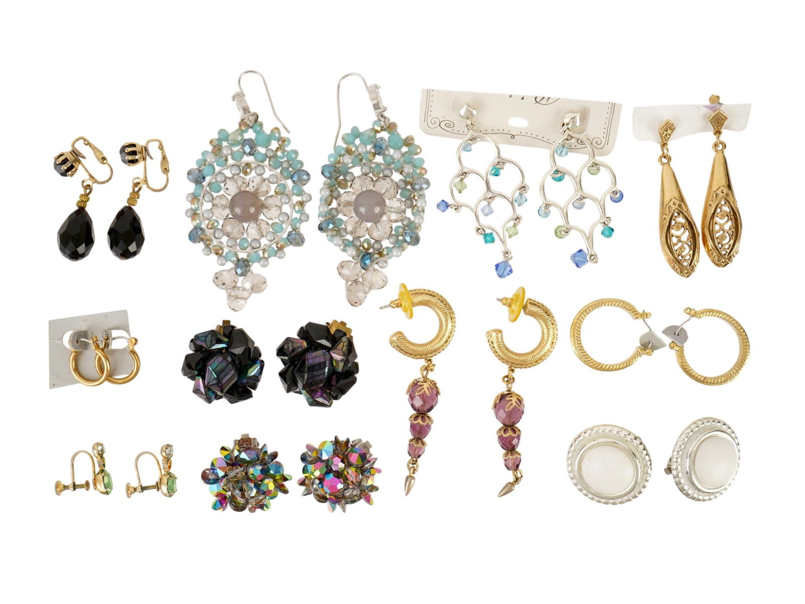 COLLECTION OF 11 PAIRS COSTUME JEWELRY EARRINGS: A collection of costume jewelry, primarily consisting of 11 pairs of earrings in diverse styles and finishes. The assembly includes gold-tone textured hoops, crescent moon dangles with purple stone ac