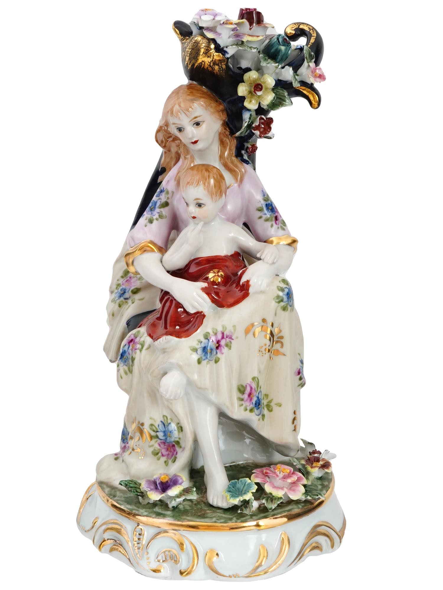 GLAZED PORCELAIN FIGURINE OF WOMAN WITH CHILD: A polychrome glazed porcelain figurine of a woman with a child marked on the bottom with the inscription Top Grade Hand Made. The tabletop figurine of a fair haired woman, dressed in 19th century
