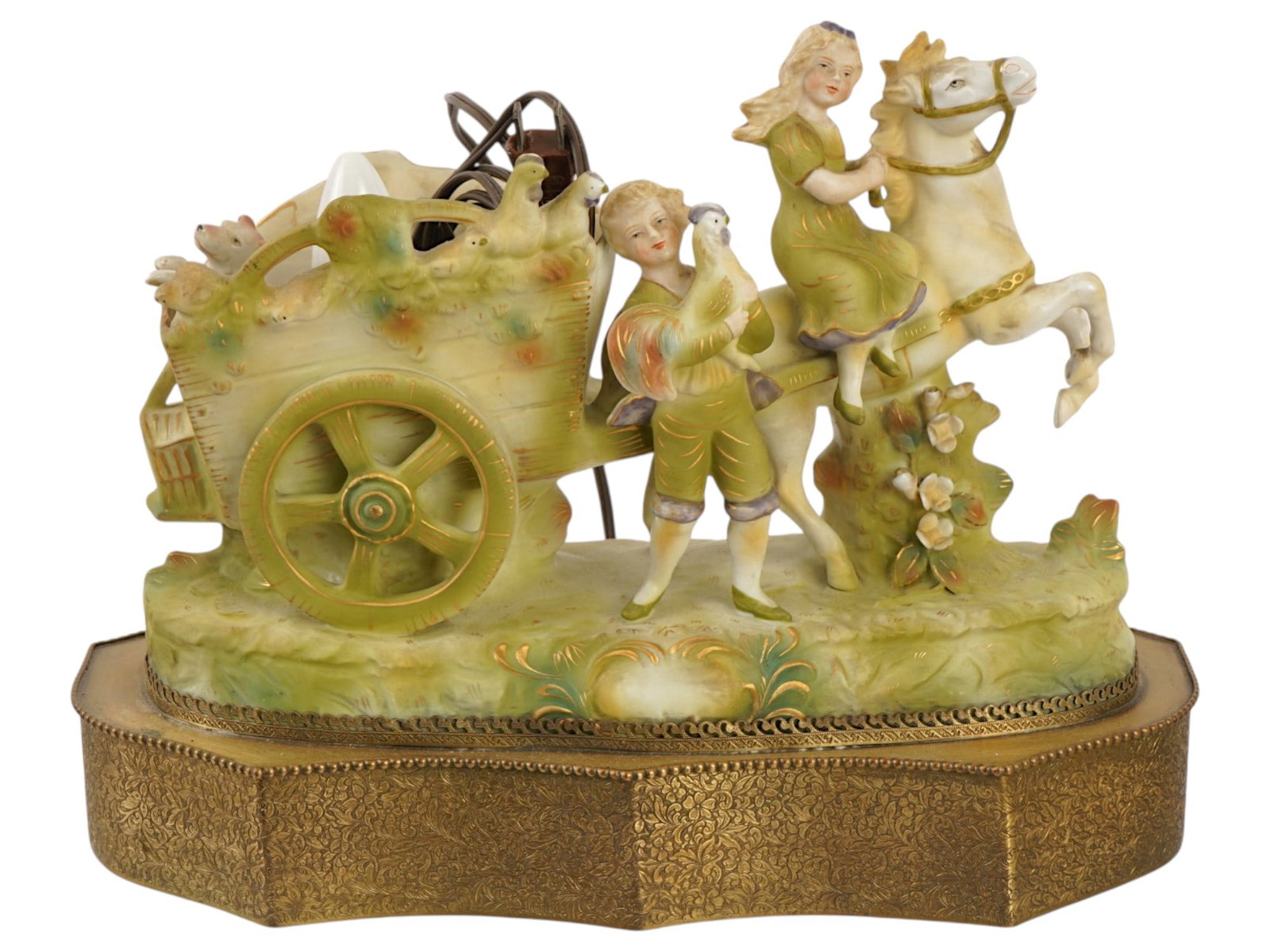 VINTAGE ITALIAN BISQUE PORCELAIN TABLE LAMP: A vintage Italian bisque porcelain table lamp featuring a pastoral figural scene, mounted on an ornate brass plinth base. Executed in hand-painted pastel tones, the composition depicts a young girl ri
