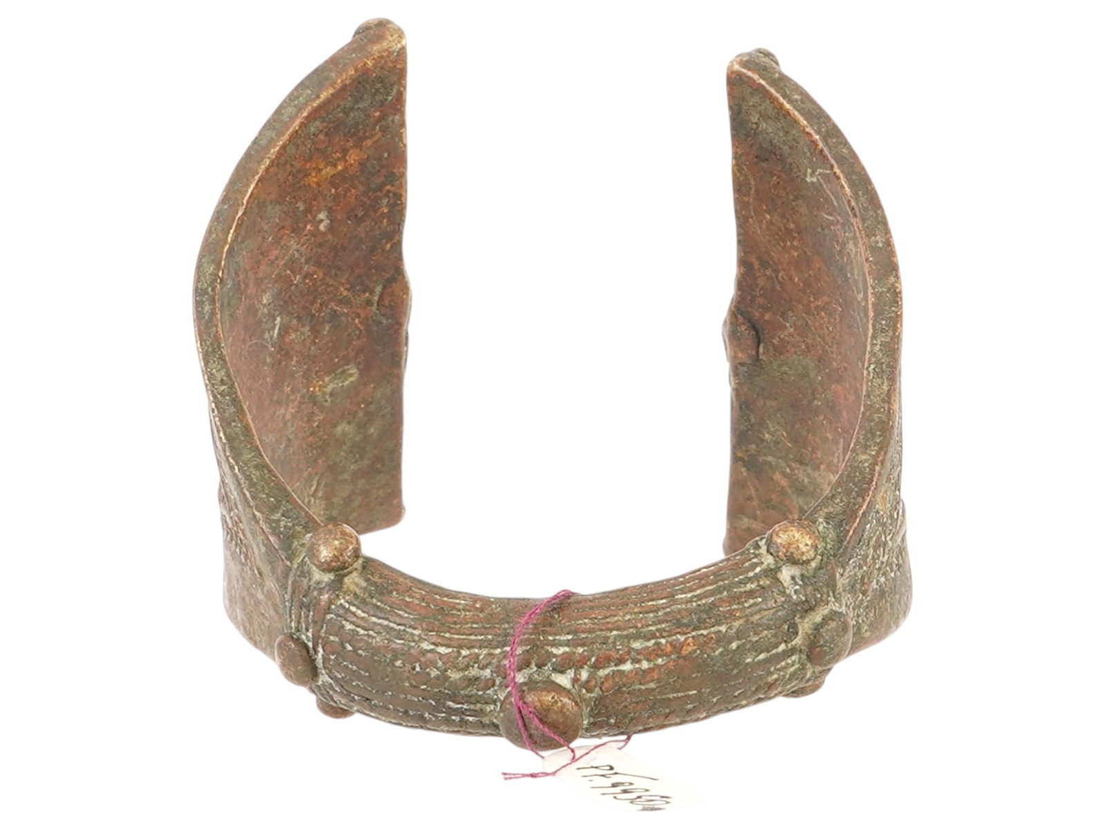 ANTIQUE WEST AFRICAN YORUBA BRONZE CUFF BRACELET: An antique West African Yoruba bronze cuff bracelet. Circa the late 19th to early 20th century. The wide bronze bracelet, tapered in the center and decorated with braided and twisted patterns and moti