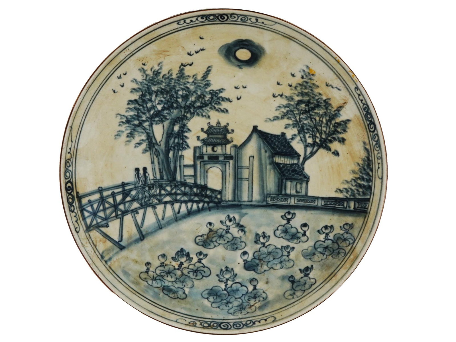 RARE LARGE VIETNAMESE HANOI BAT TRANG CERAMIC PLATE: A rare large Vietnamese Hanoi Bat Trang ceramic plate. The plate is adorned with a hand painted Hanoi scene with two women in a landscape with a building view. Marked with a stamp, Vietnam Bat Trang, 