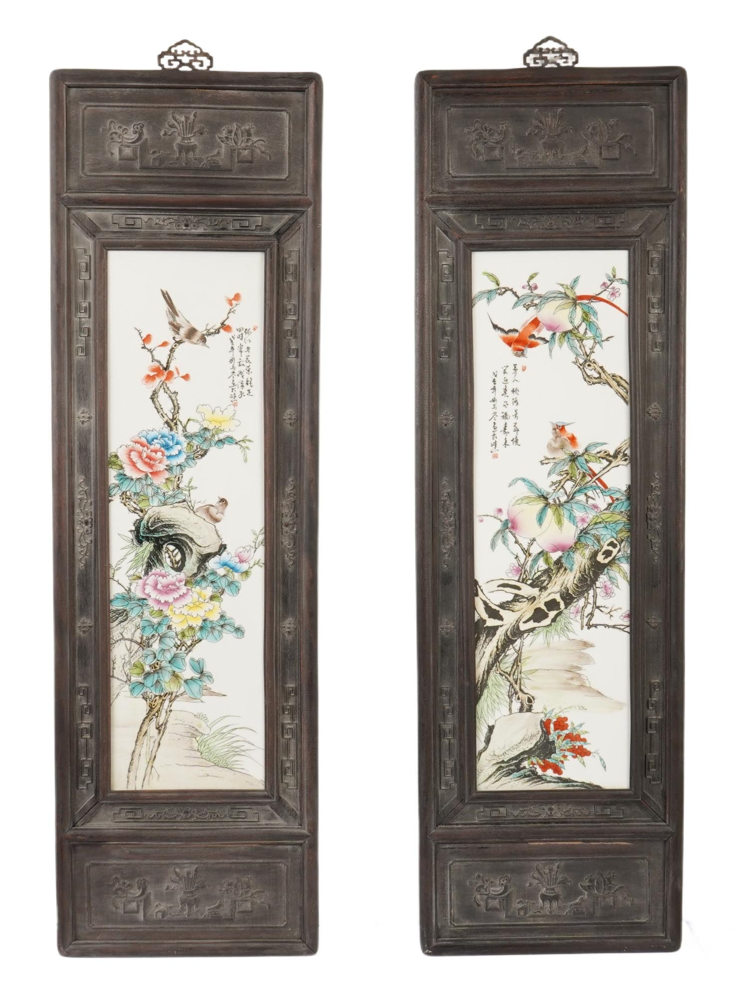 CHINESE PAINTINGS ON PORCELAIN IN CARVED FRAMES: A pair of matching Chinese paintings on porcelain. Vertical rectangular plaque. The pieces depict peach trees, blossoms, and birds. Poetic inscriptions with artists seal in the upper parts. Fine hand-