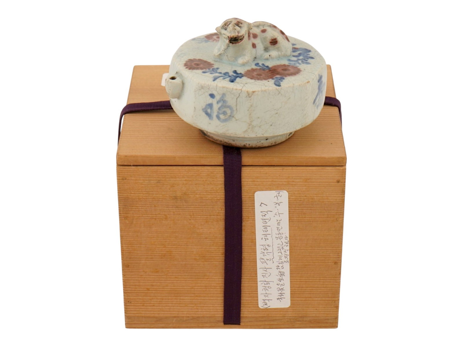 ANTIQUE 19TH C KOREAN JOSEON PORCELAIN WATER DROPPER: An antique 19th-century Korean Joseon Dynasty porcelain water dropper features a molded Haetae figure resting atop a flattened circular body. The exterior is decorated with underglaze copper-red bloss