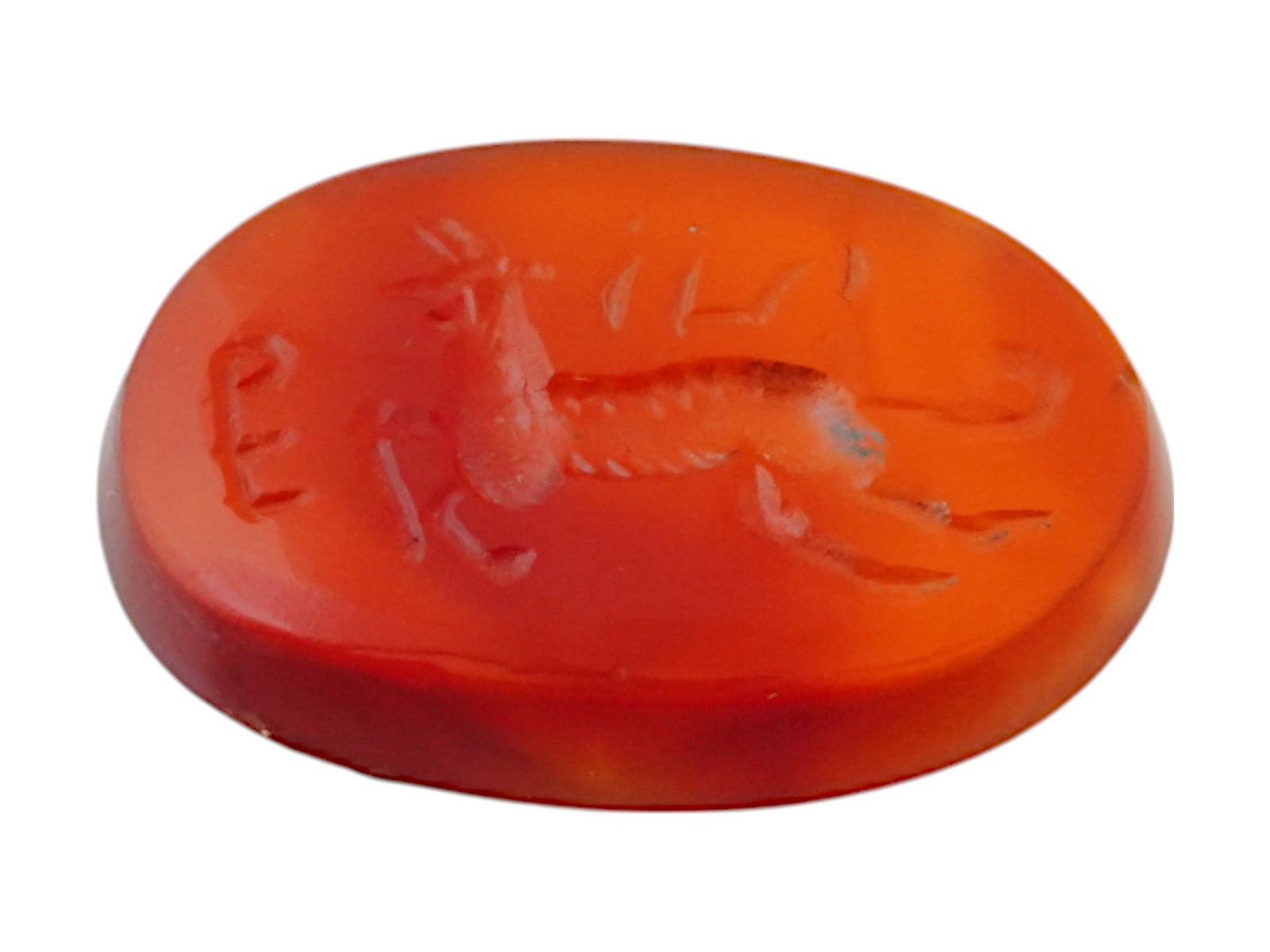 ANCIENT PERSIAN CARVED CARNELIAN INTAGLIO HORNED ANIMAL: An ancient Persian carved carnelian intaglio, dating to circa 200 BC, finely engraved with a horned leaping animal, possibly a mythical or royal beast, surrounded by ancient Persian inscriptions. Like