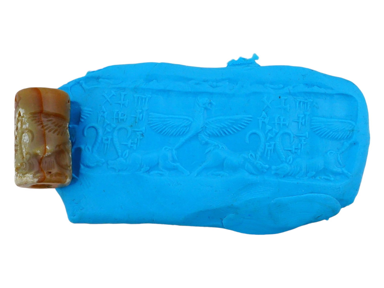 SUMERIAN AND GREEK INLAY SLANDER AGATE SEAL 1000 BC: An ancient Sumerian and Greek cylinder shaped seal inlaid and hand carved slander Agate stone seal. The seal depicts traditional symbols, mythological creatures, animal figures and Calligraphy.