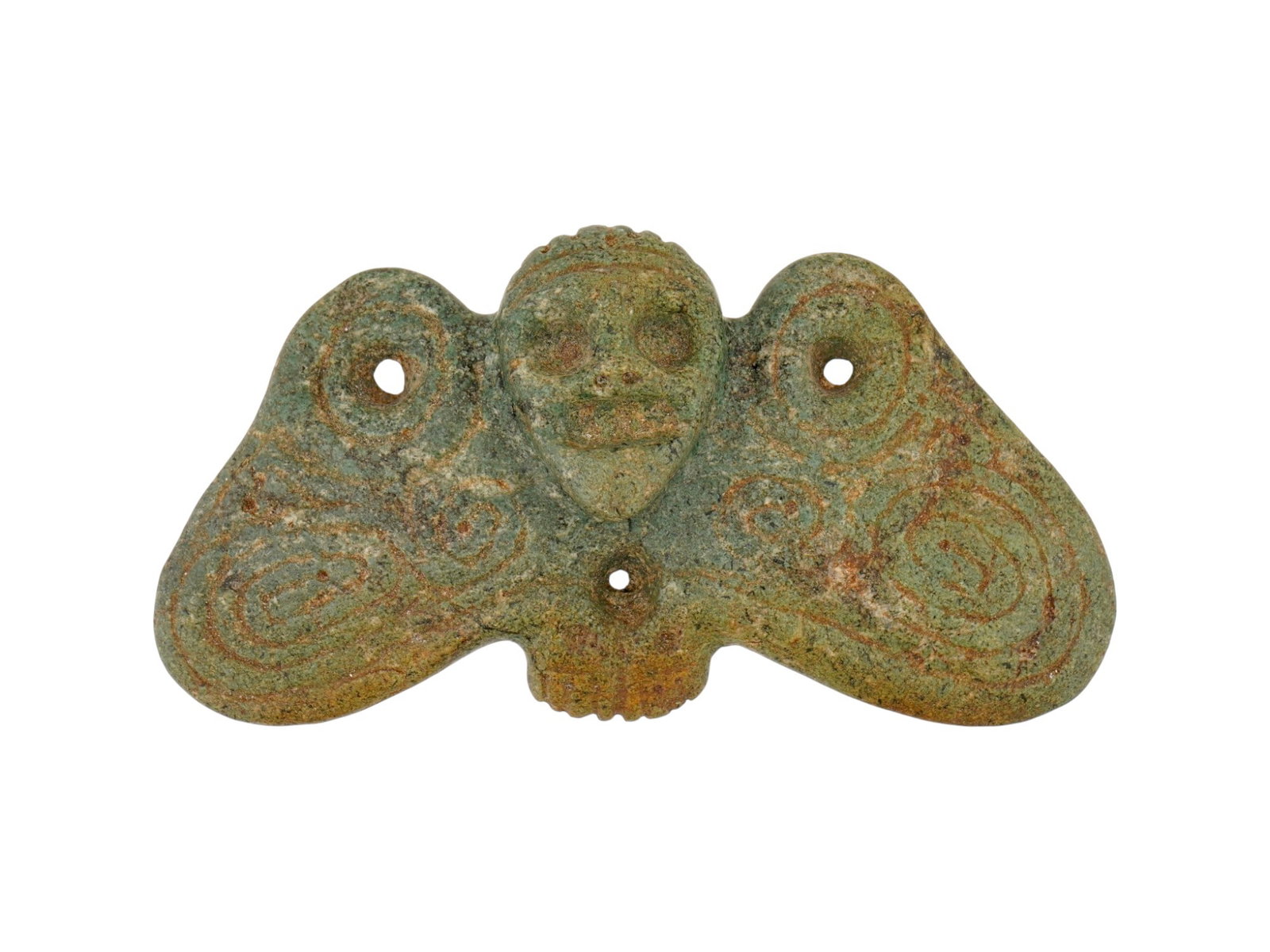 PRE COLUMBIAN TAINO CARVED GREEN STONE BATMAN FIGURINE: An ancient Pre Columbian Taino hand carved green stone batman figurine featuring a central anthropomorphic face with prominent circular eyes and a wide mouth. The figure is flanked by two broad, styli