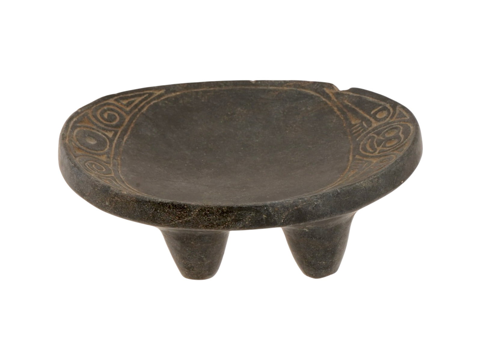 ANCIENT PRE COLUMBIAN TAINO HAND CARVED STONE STOOL: An ancient Pre Columbian hand carved stone object represents a miniature duho, or ceremonial stool, originating from the Taino culture. The piece features an oval, slightly concave platform supported 