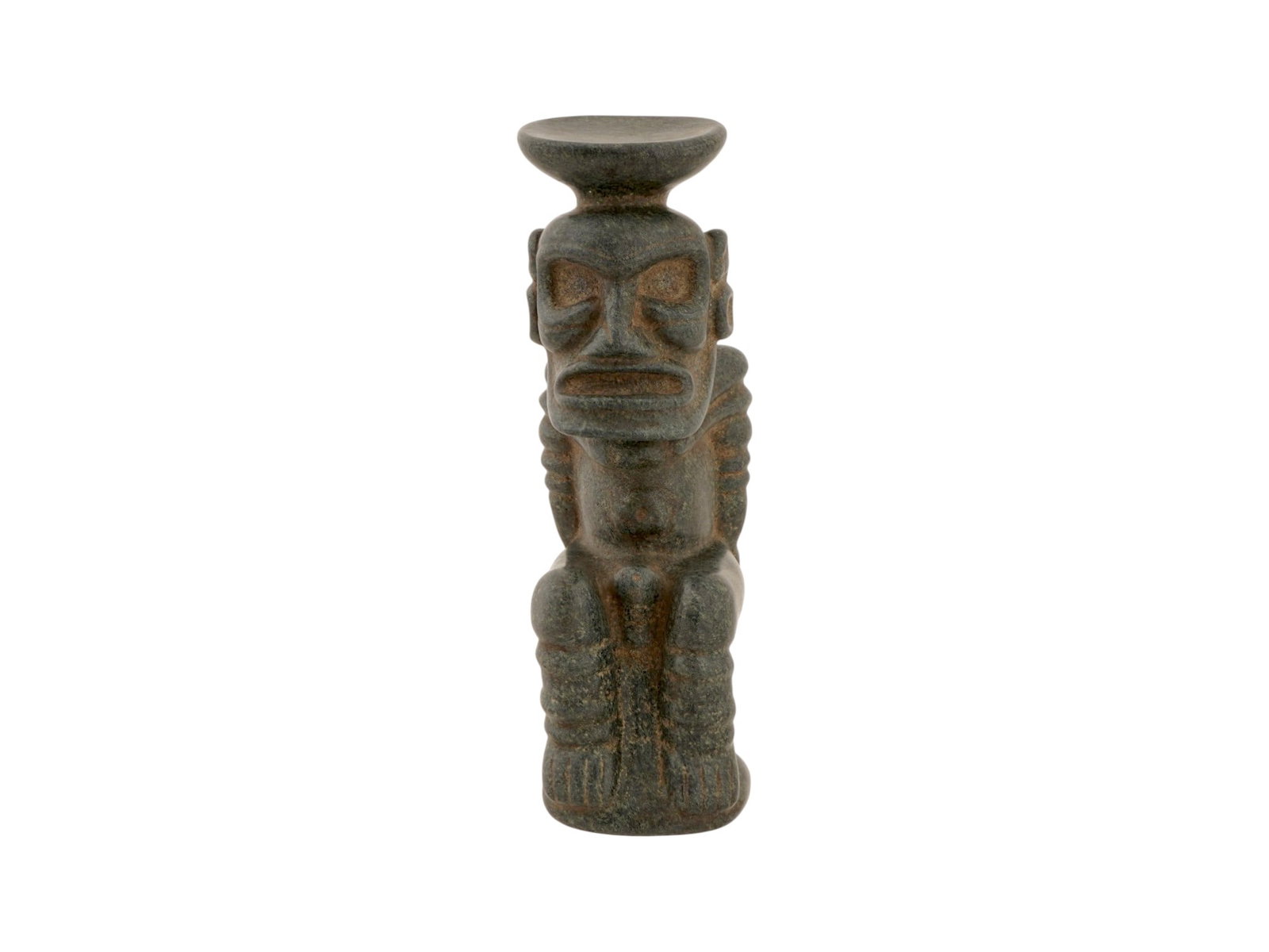 ANCIENT PRE COLUMBIAN TAINO STONE ANTHROPIC FIGURE: An ancient Pre Columbian Taino hand carved stone Anthropic figurine. The figure depicts a squatting posture with hands resting upon the knees, featuring a large, stylized head with deep orbital socket