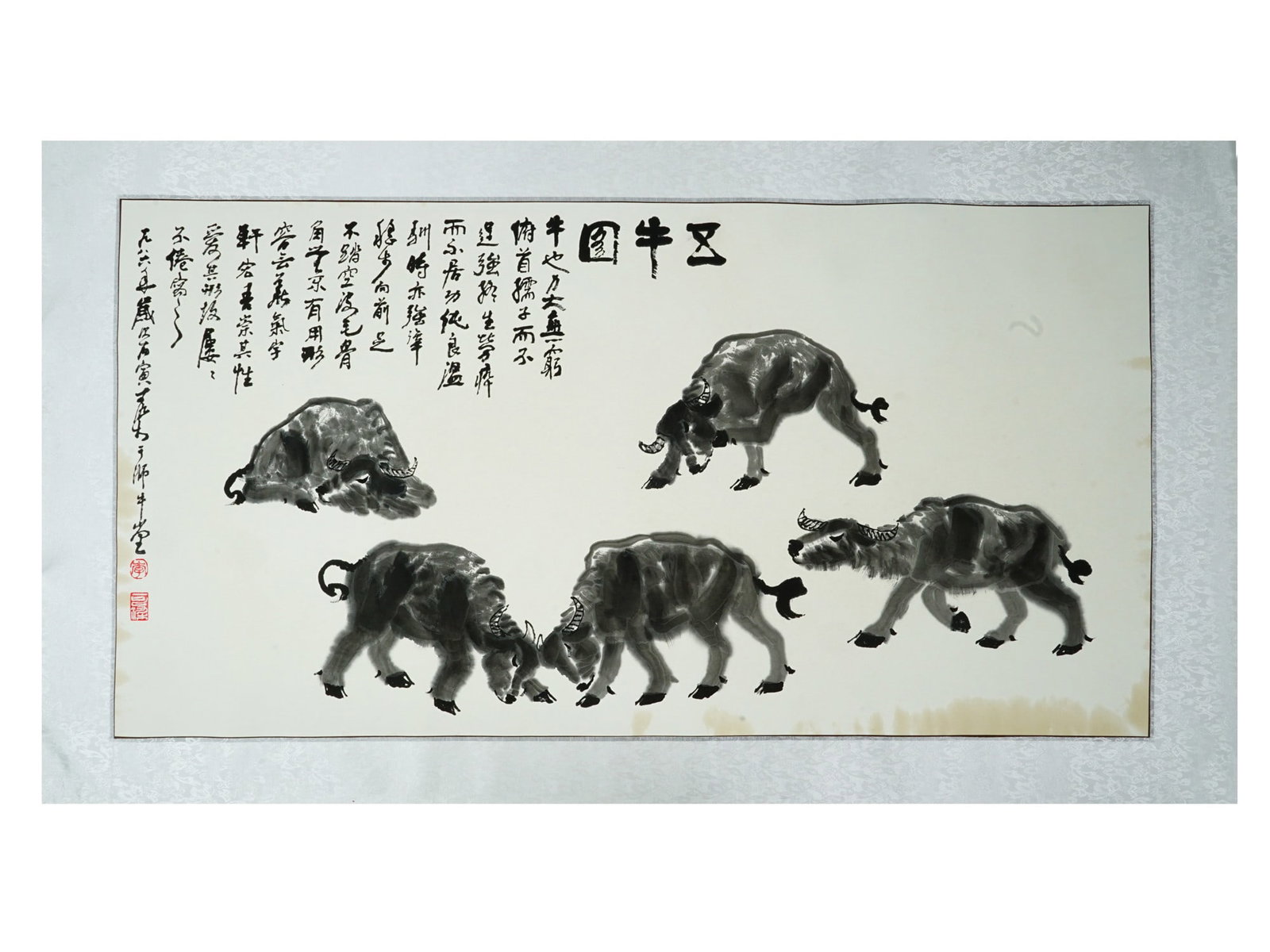 CHINESE LI KERAN MANNER INK AND WATERCOLOR PAINTING: A Chinese ink and watercolor painting on paper depicting a figurative composition with five bulls in the style of Li Keran, a renowned 20th century Chinese artist known for his monumental mountain lan