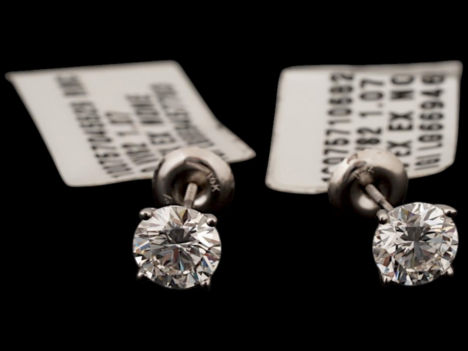 14K WHITE GOLD 2 CARAT LAB GROWN DIAMOND EARRINGS: This lot features a pair of classic lab-grown diamond stud earrings set in polished 14K white gold. The stones boast a combined total weight of 2.14 carats with a VVS2 D Grade, offering excellent bril