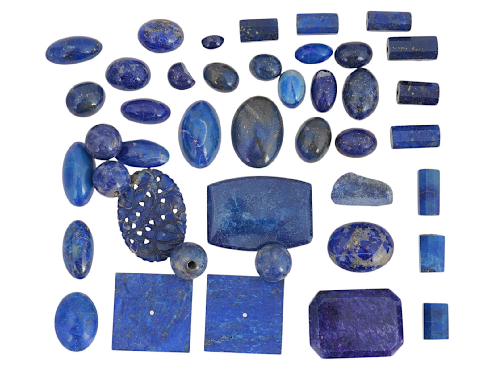 COLLECTION OF VARIOUS LAPIS LAZULI BEADS FOR NECKLACE: A collection of lapis lazuli beads in various shapes and sizes. There is a range of cuts and finishes including cabochons, beads, faceted pieces, rectangles, squares, ovals, and a carved floral decora