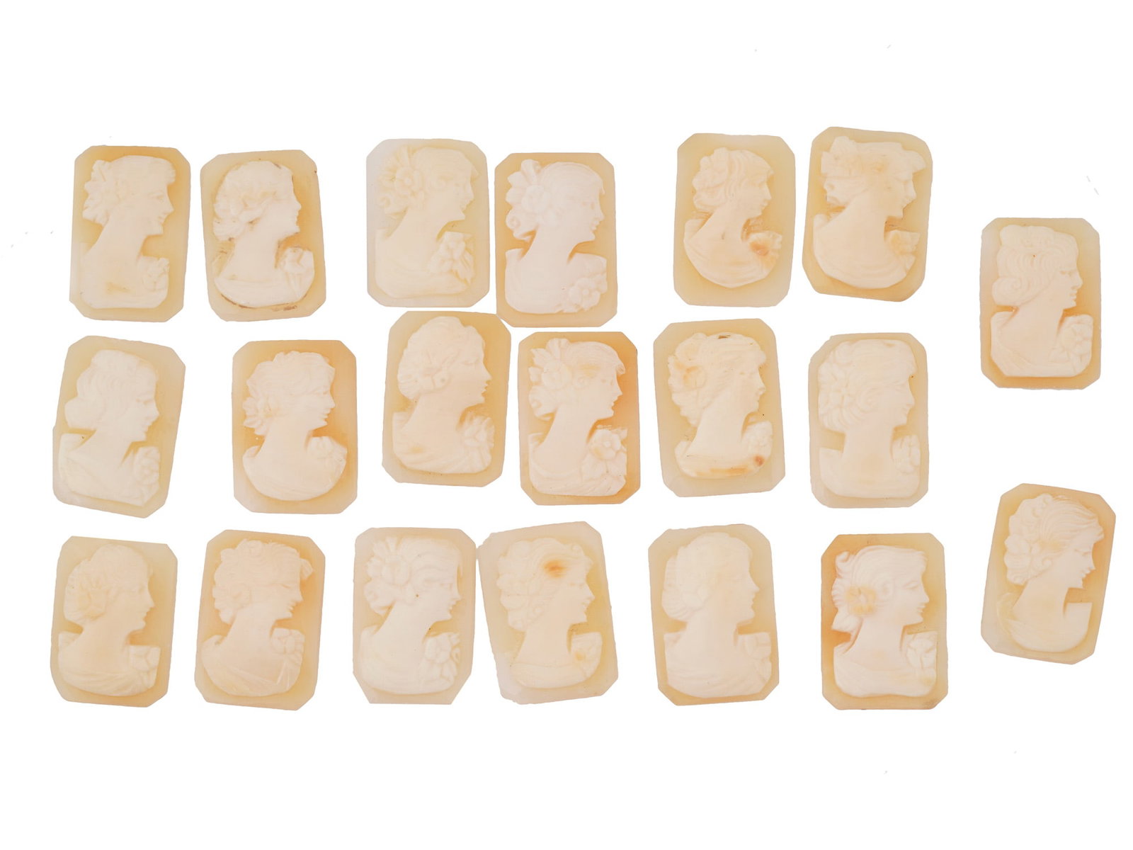 COLLECTION OF CARVED FEMALE PORTRAIT SHELL CAMEOS: A collection of hand carved shell cameos. Each piece depicts a female profile portrait rendered in high relief in the Victorian manner. Each cameo is fashioned in a distinctive octagonal medallion