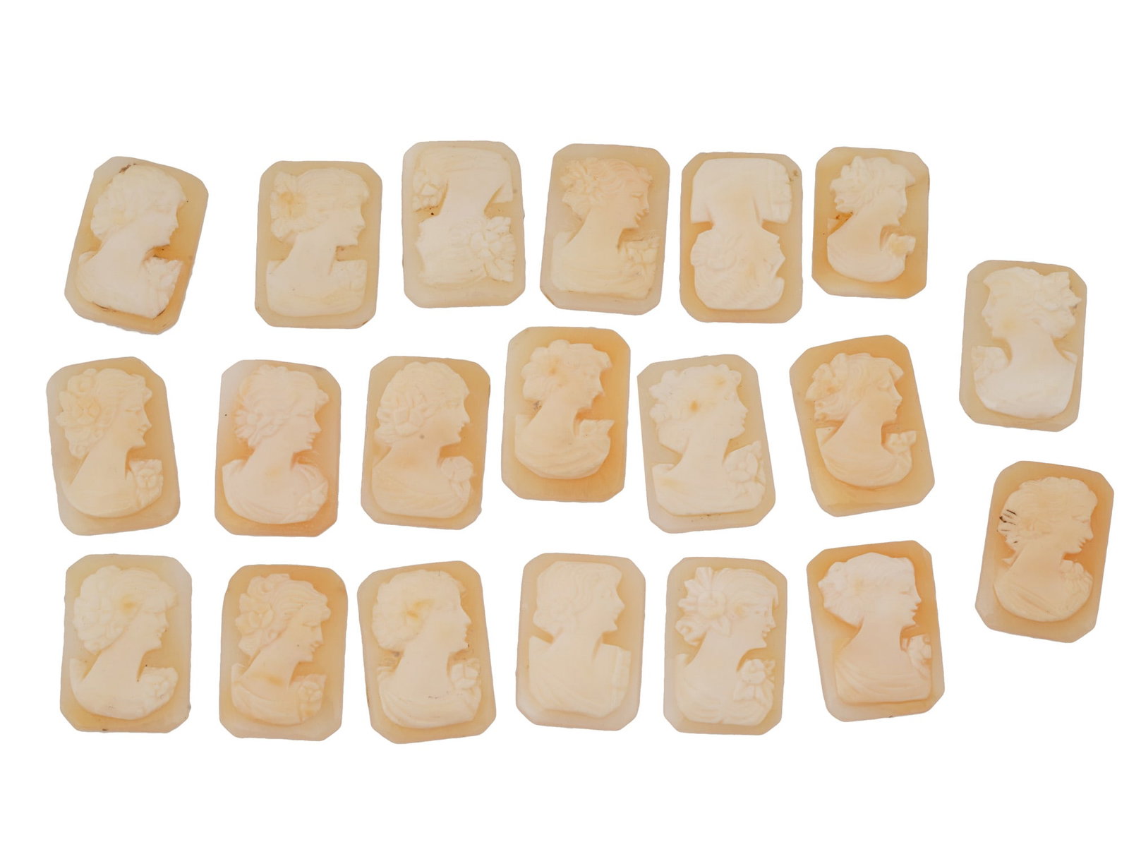 COLLECTION OF CARVED FEMALE PORTRAIT SHELL CAMEOS: A collection of hand carved shell cameos. Each piece depicts a female profile portrait rendered in high relief in the Victorian manner. Each cameo is fashioned in a distinctive octagonal medallion