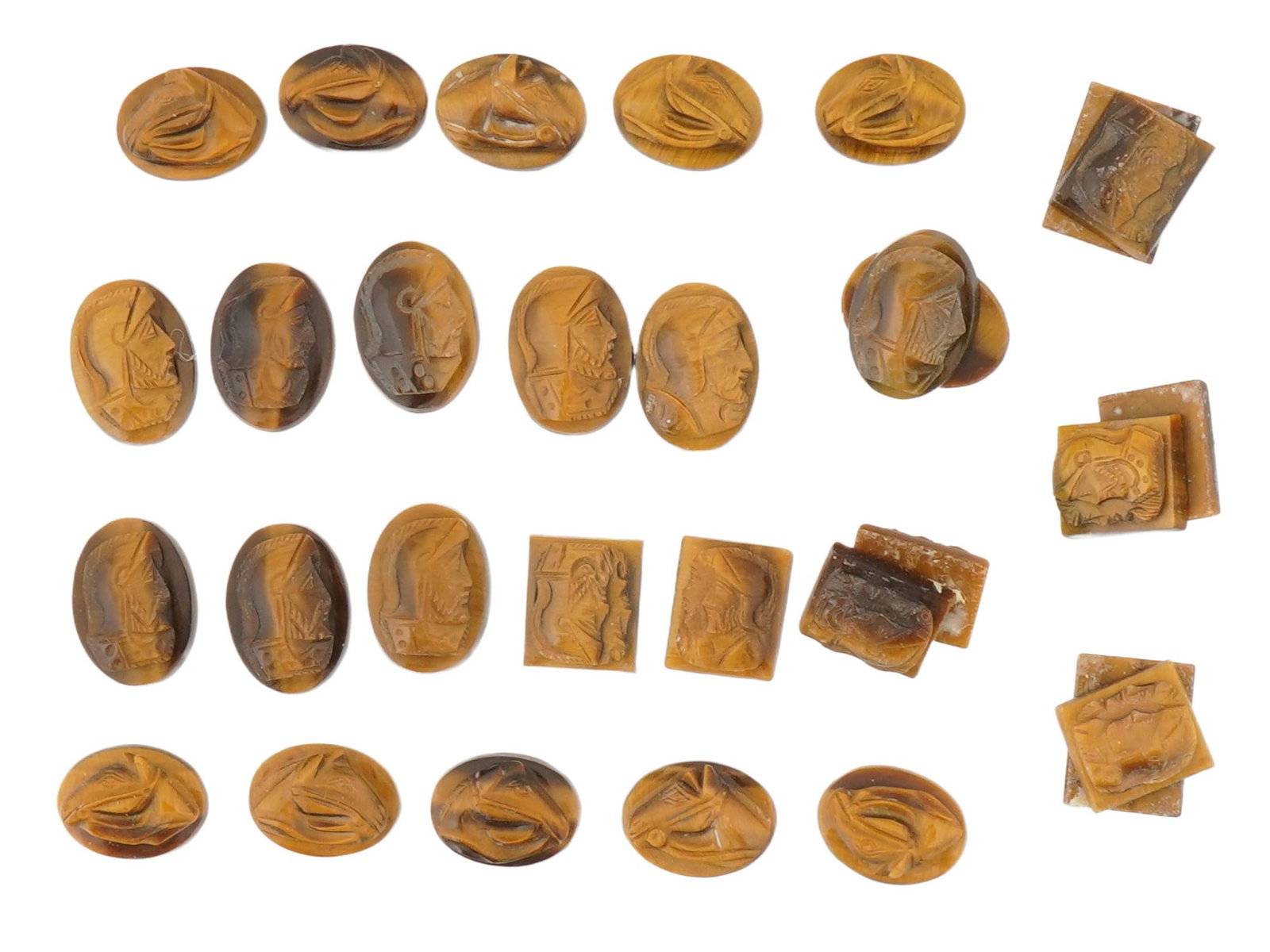 COLLECTION OF PORTRAIT CARVED TIGERS EYE CAMEOS: A collection of hand carved tigers eye cameos. A total of 30 items. Each piece features a knight profile portrait rendered in high relief. Square and oval shape. Collectible Jewelry And Glyptic Art,