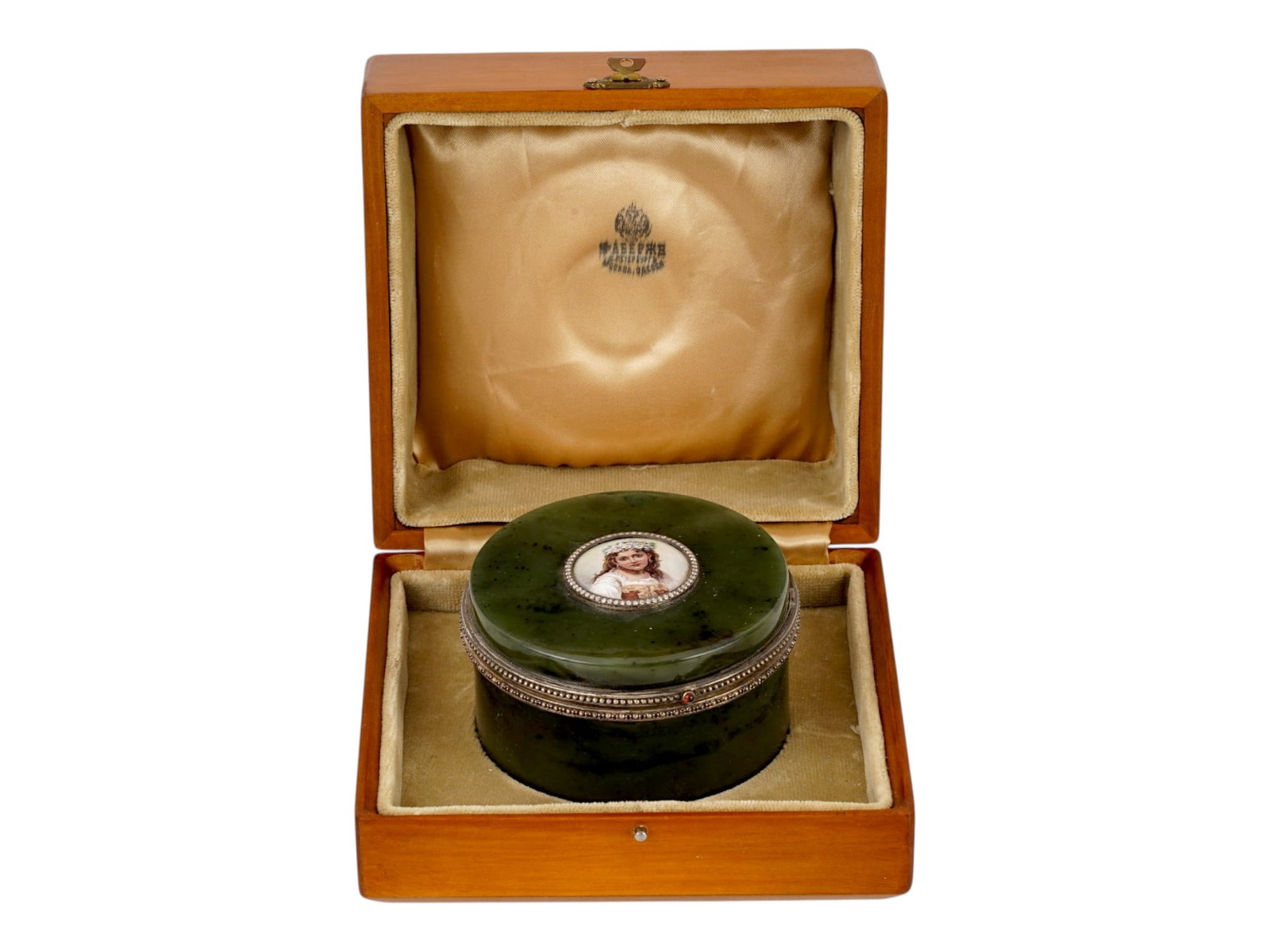 RUSSIAN NEPHRITE JADE JEWELRY BOX W ENAMEL MINIATURE: A Russian circular jewelry box carved from green nephrite jade and set. The lid features a hand-painted enamel portrait miniature surrounded by a circle of diamonds, framed by silver mounts accented w